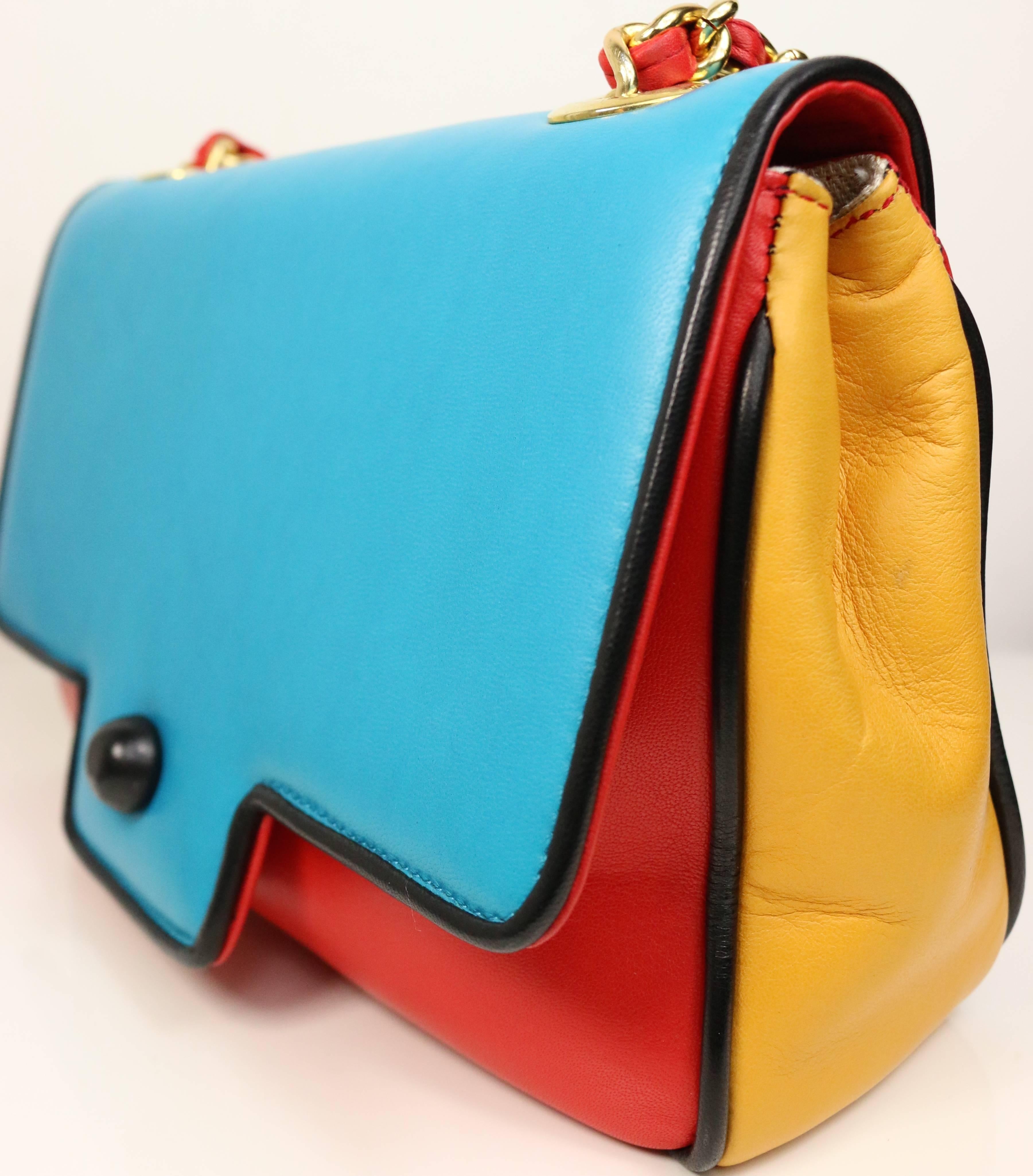 - Vintage 80s Pancaldi colour blocked(turquoise/red/yellow) leather with black piping trim red leather gold chain strap crossbody bag. Linen Fabric interior. 

- Length: 8in, Height: 5.5in, Strap: 22in. 

- Made in Italy. 