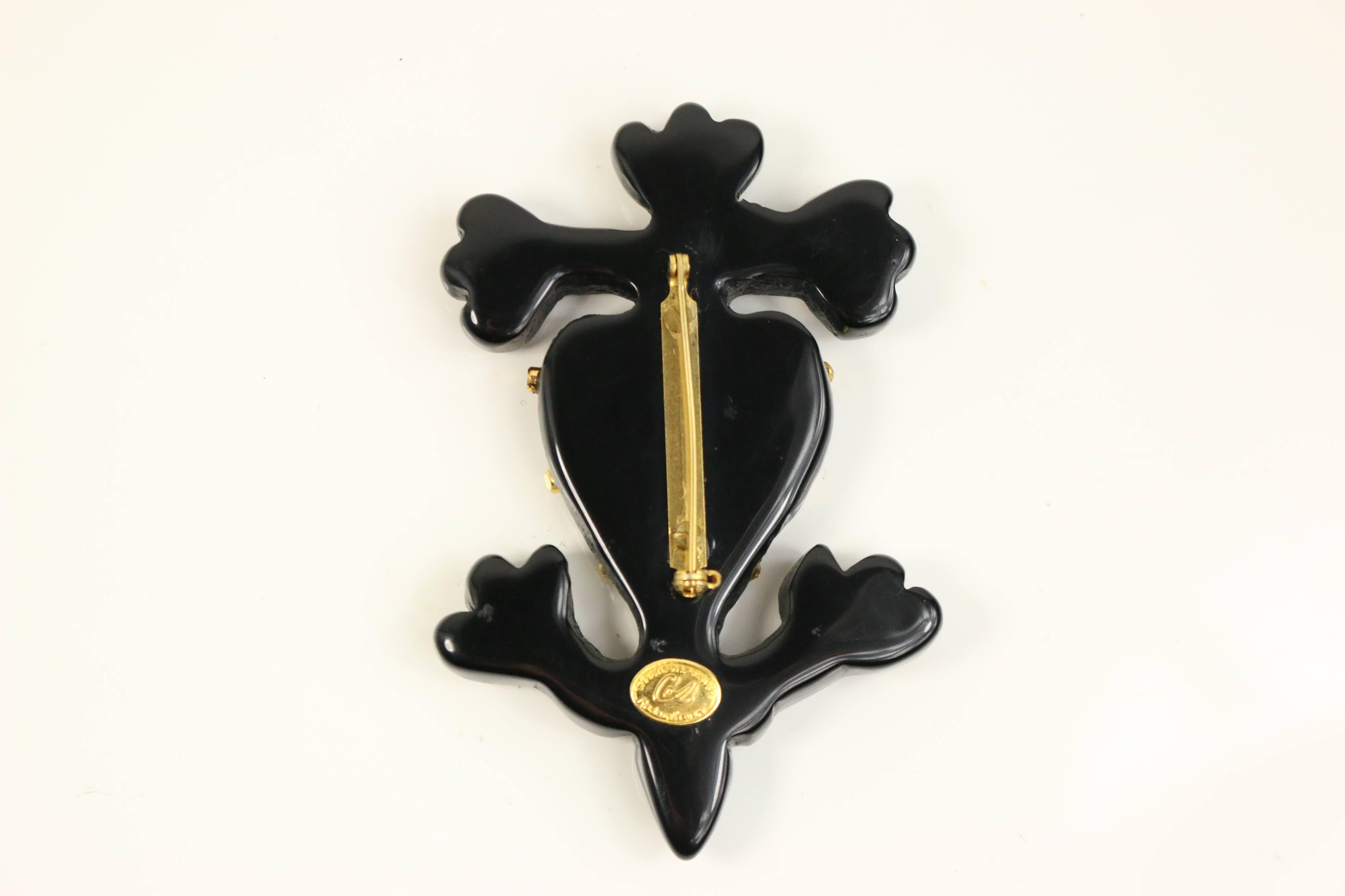 - Vintage 80s Christian Lacroix black with gold tone "sailor" like brooch with heart in in the center. 

- Made in Italy. 

- Height: 3.25 inches. Width: 2 inches. 

