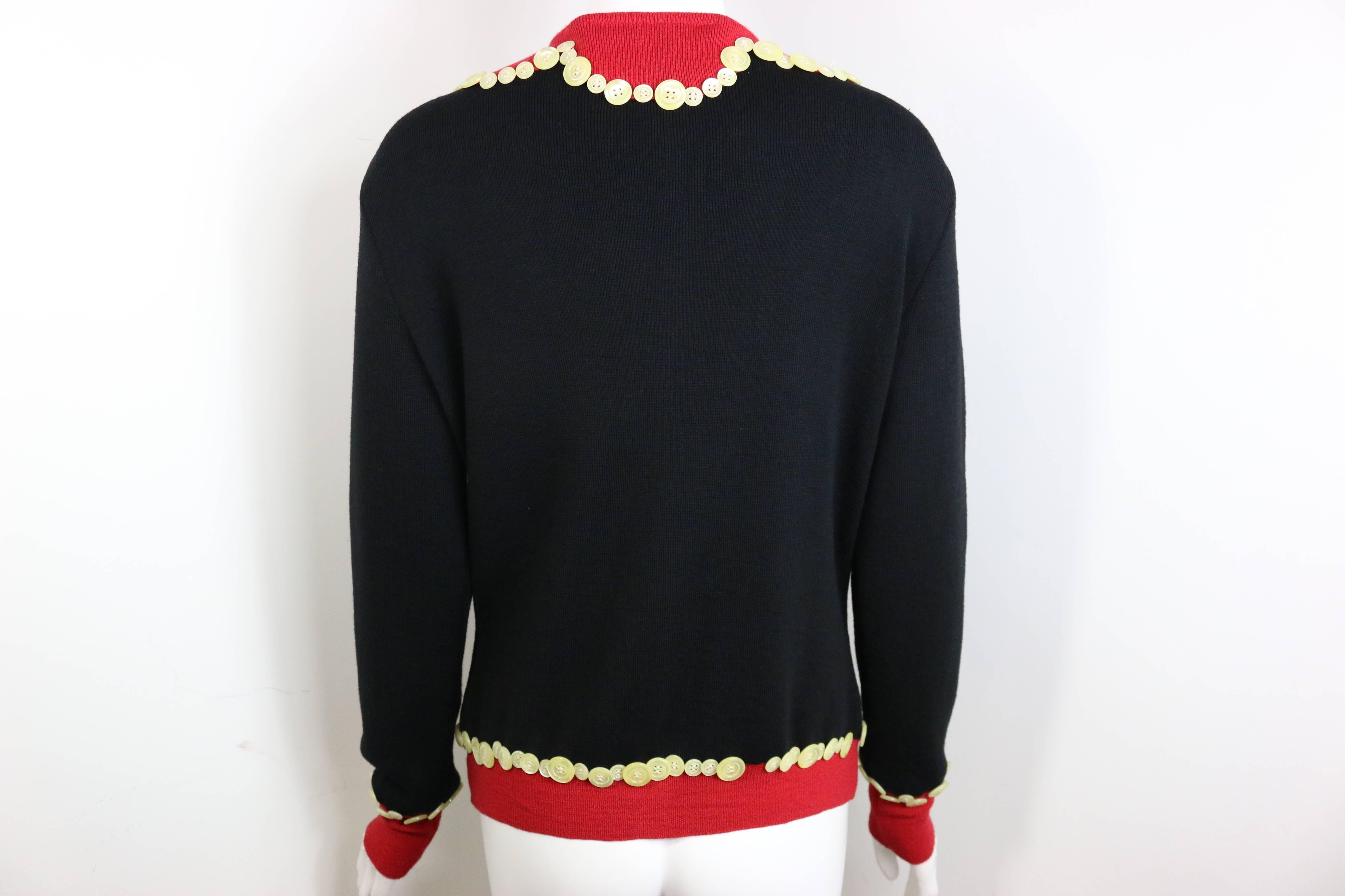 - Vintage 90s Moschino Cheap and Chic black/red with mother of pearl buttons wool cardigan. 

- Featuring six front mother of pearl buttons closing. Red Cuffs and hem. 

- 100% Wool. 

- Made in Italy. 

- Size 44 IT. 

- Bust: