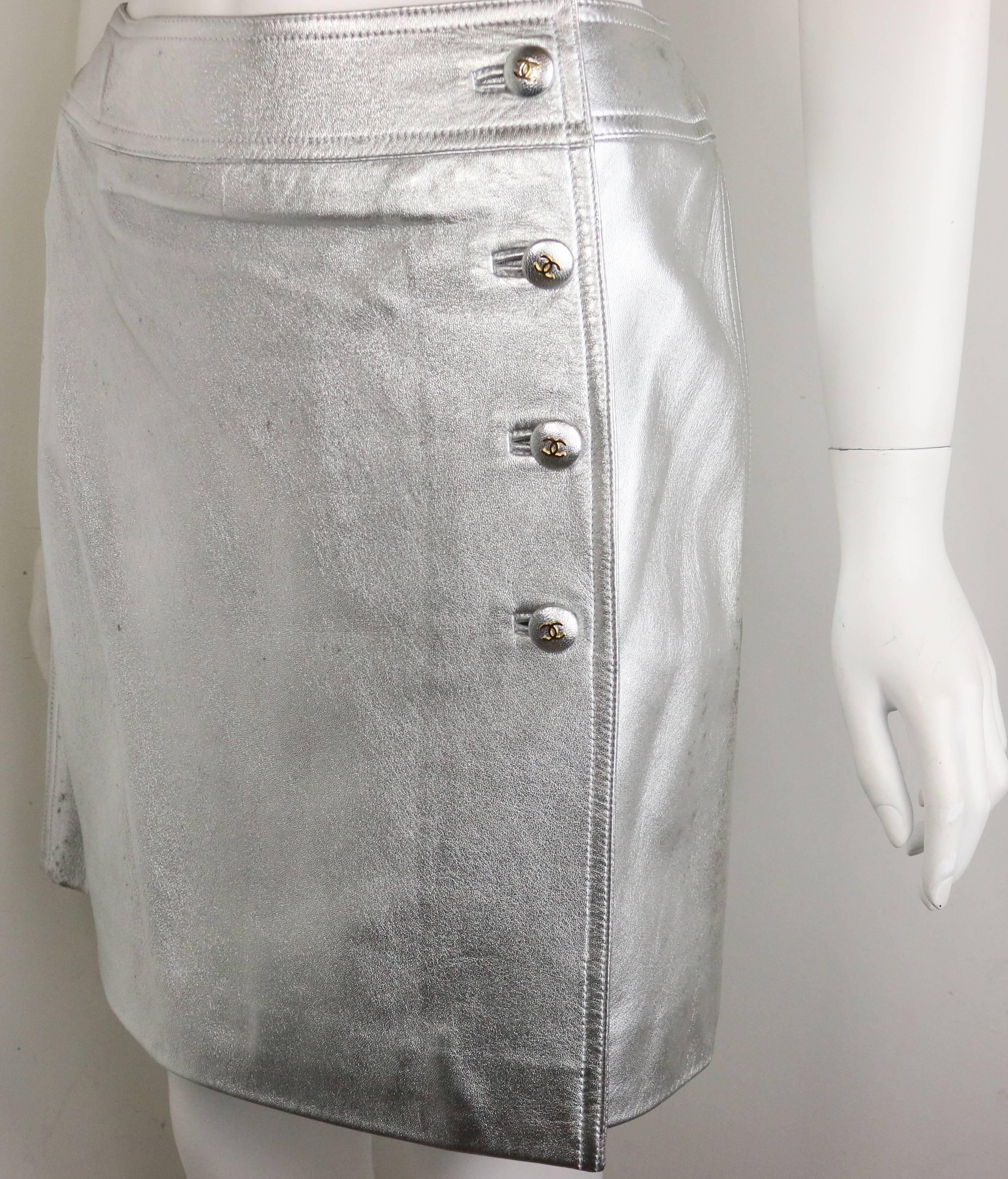 - Chanel silver metallic lambskin leather wrap skirt from Fall 1996 collection. 

- Featuring four silver metallic "CC" buttons down the side and a hook on the side closure. 

- Lined w CC lining. 

- Made in France. 

- Size 40.