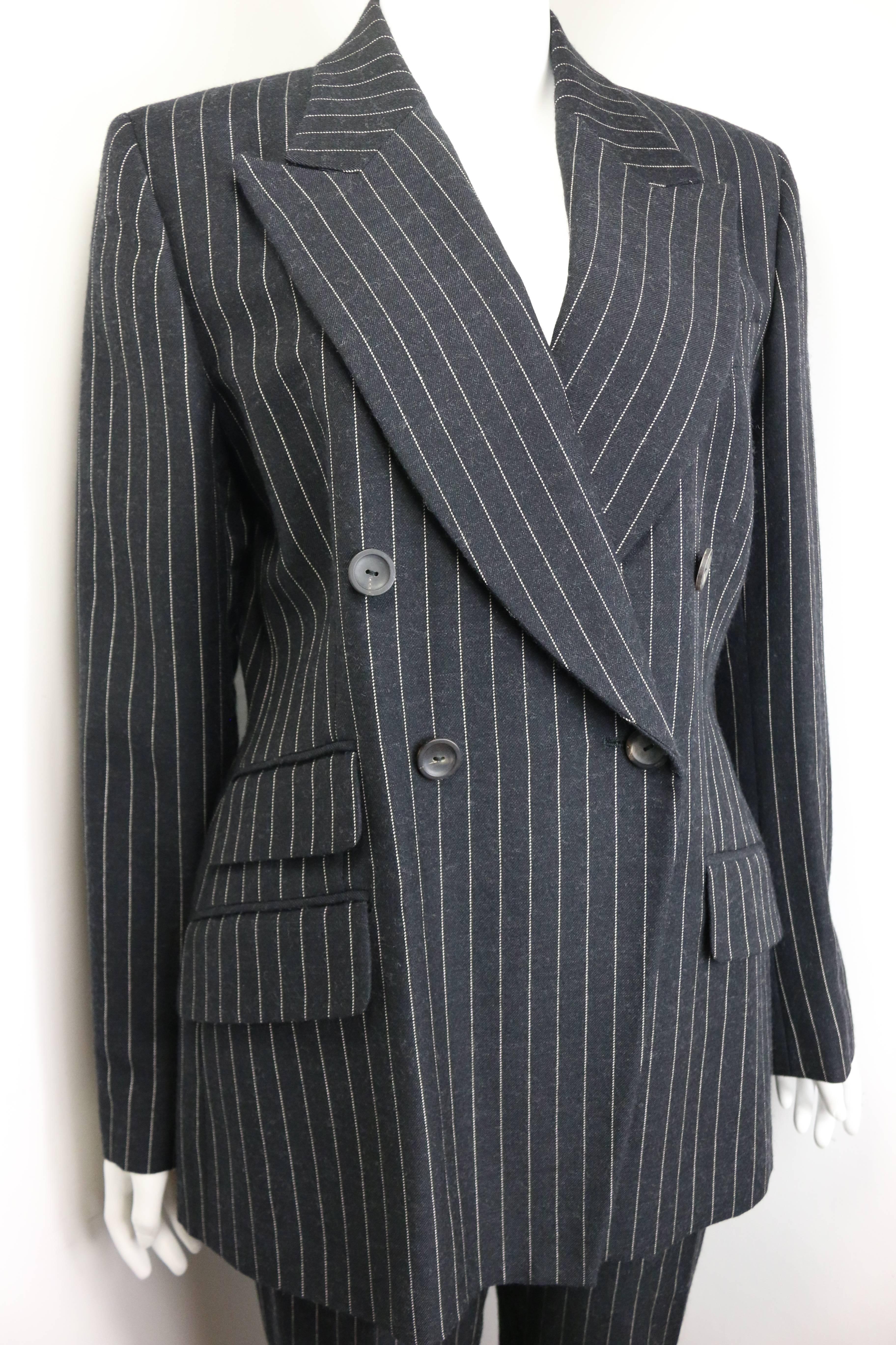 - Gucci by Tom Ford black and white pinstripe wool double breasted pants suit from fall 1996 collection. 

- Made in Italy. 

- Size 44. 

- 100% Wool. Lining: 100% Rayon. 

