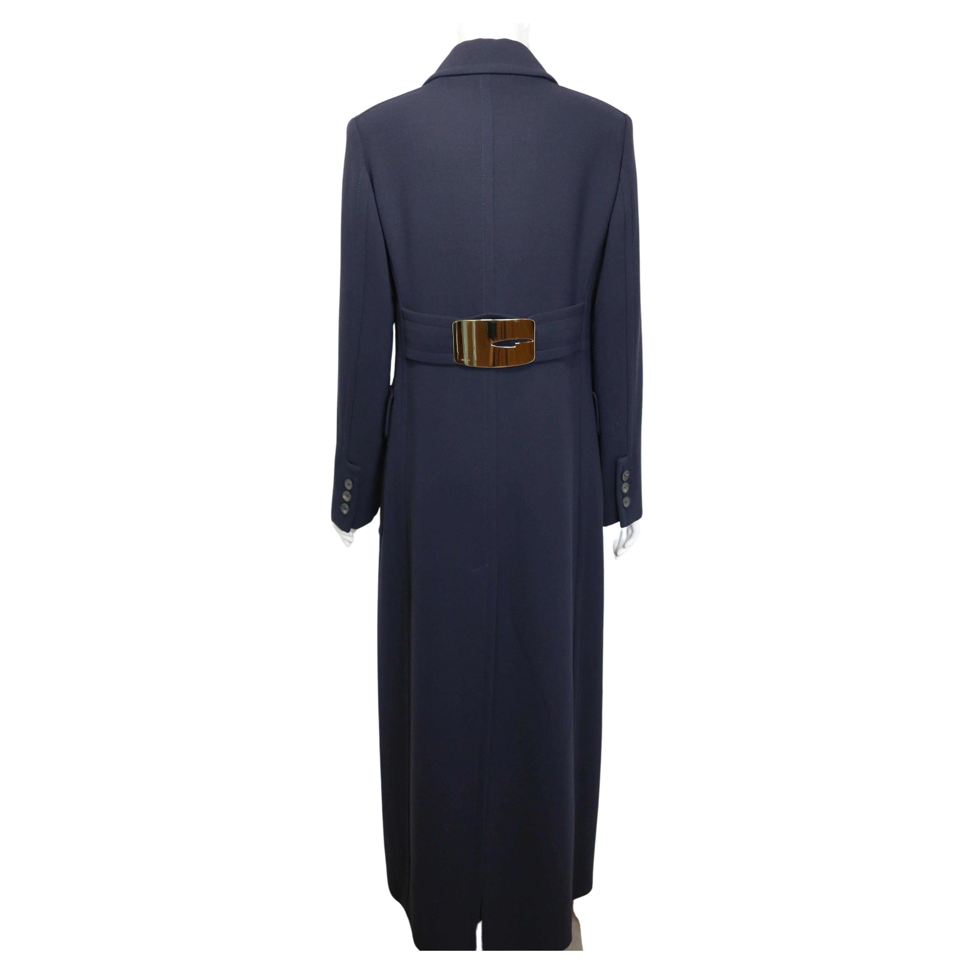-  Unworn Gucci by Tom Ford Navy Wool Maxi Coat from Fall 1996 collection. Featuring a seasonal signature gold buckle at the back. 

- Featuring epaulettes on the shoulders, a hook fastening on the collar, eight front buttons, zipper closure, three