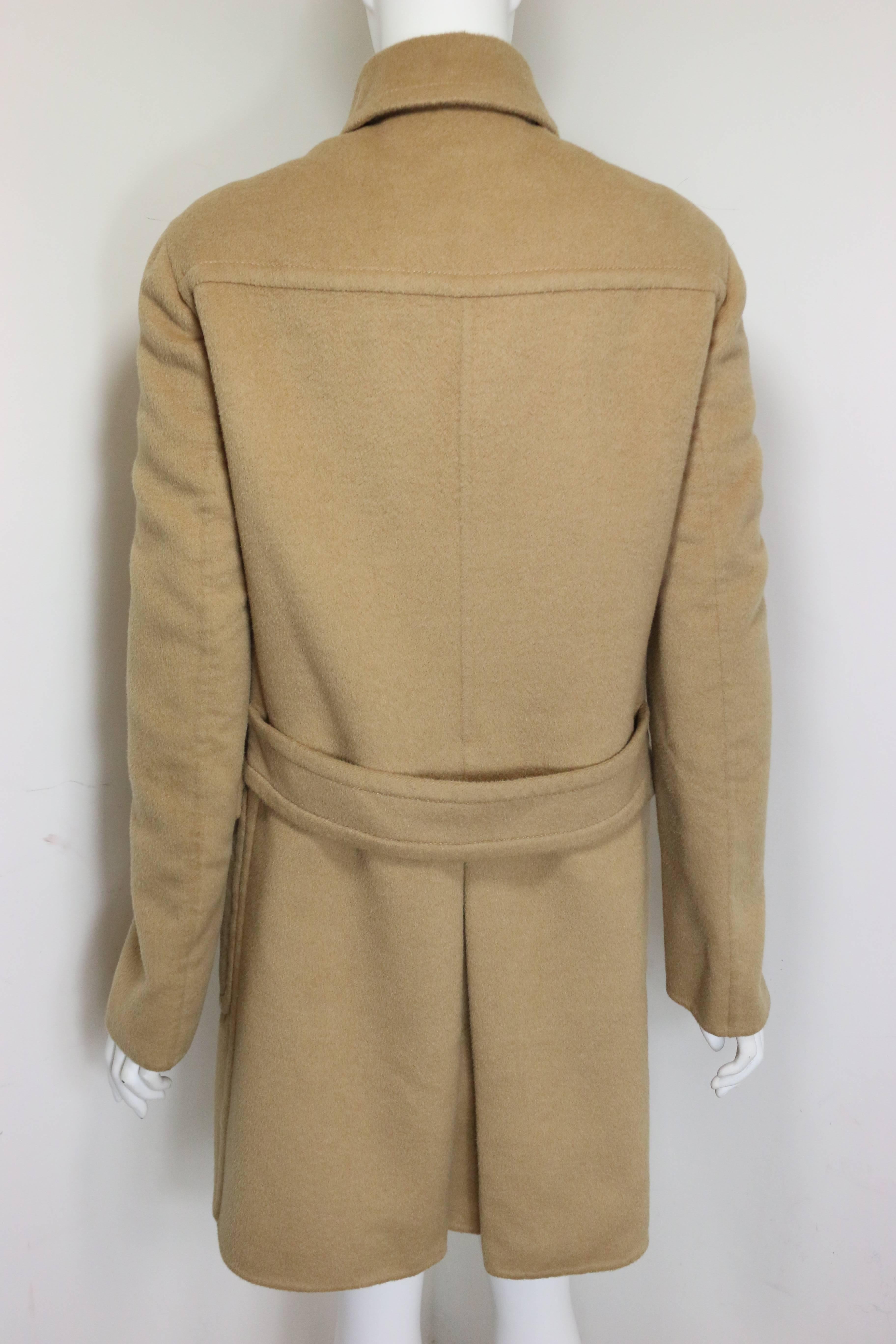 - Vintage Prada camel wool double breasted coat from fall 1996 collection.

- Featuring eight front buttons fastening, two flap pockets with buttons, and a back waist strap. 

- 52% Wool, 48% Angora Goat Hair. 

- Size 44 Italy. 