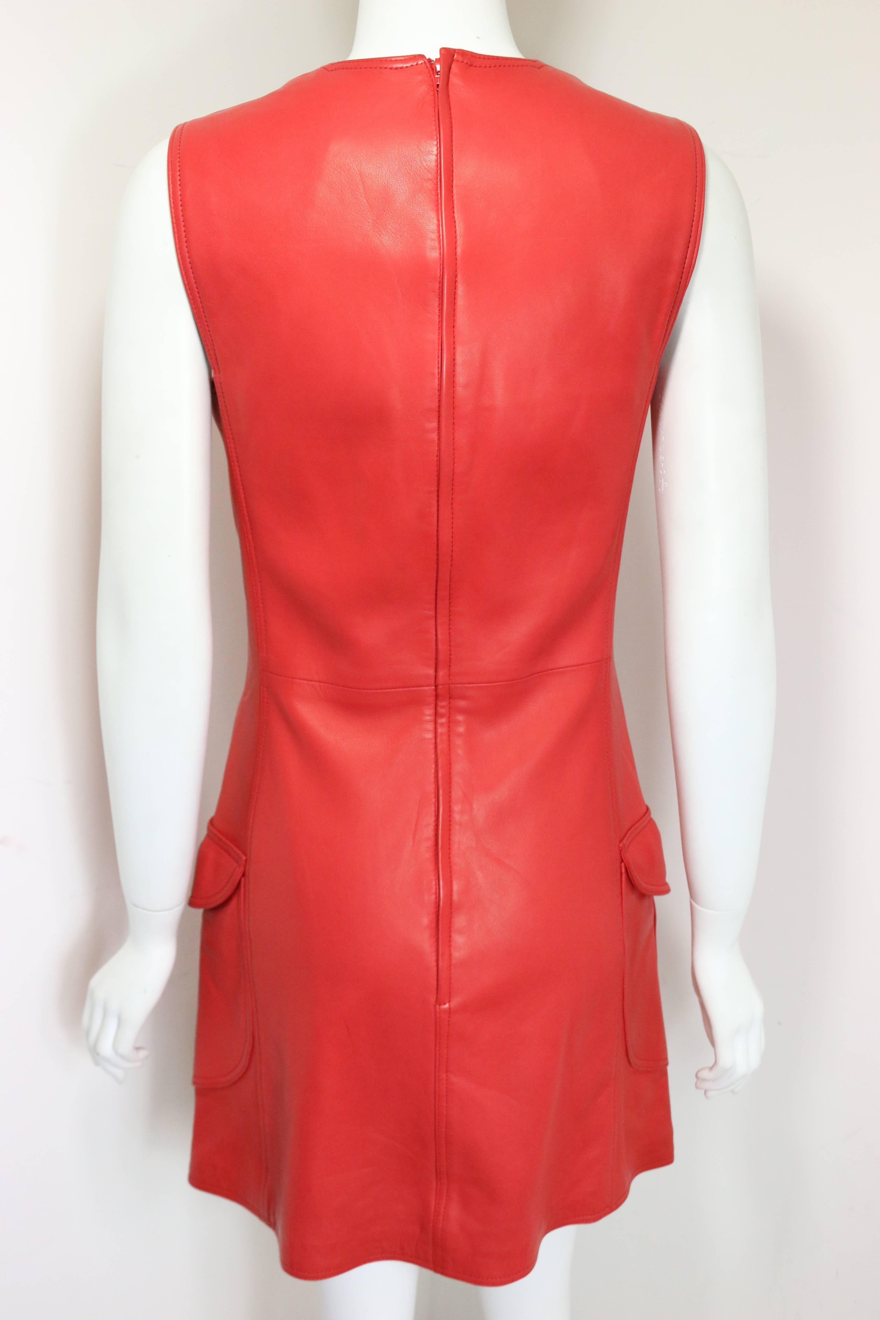 - Vintage 90s Gianni Versace red leather dress.   

- Featuring four flap pockets with signature red medusa buttons.   

- Back zipper closure.   

- Made in Italy.   

- Size 40.   

- Length: 33 inches. Bust: 32 inches. Waist: 30inches. 