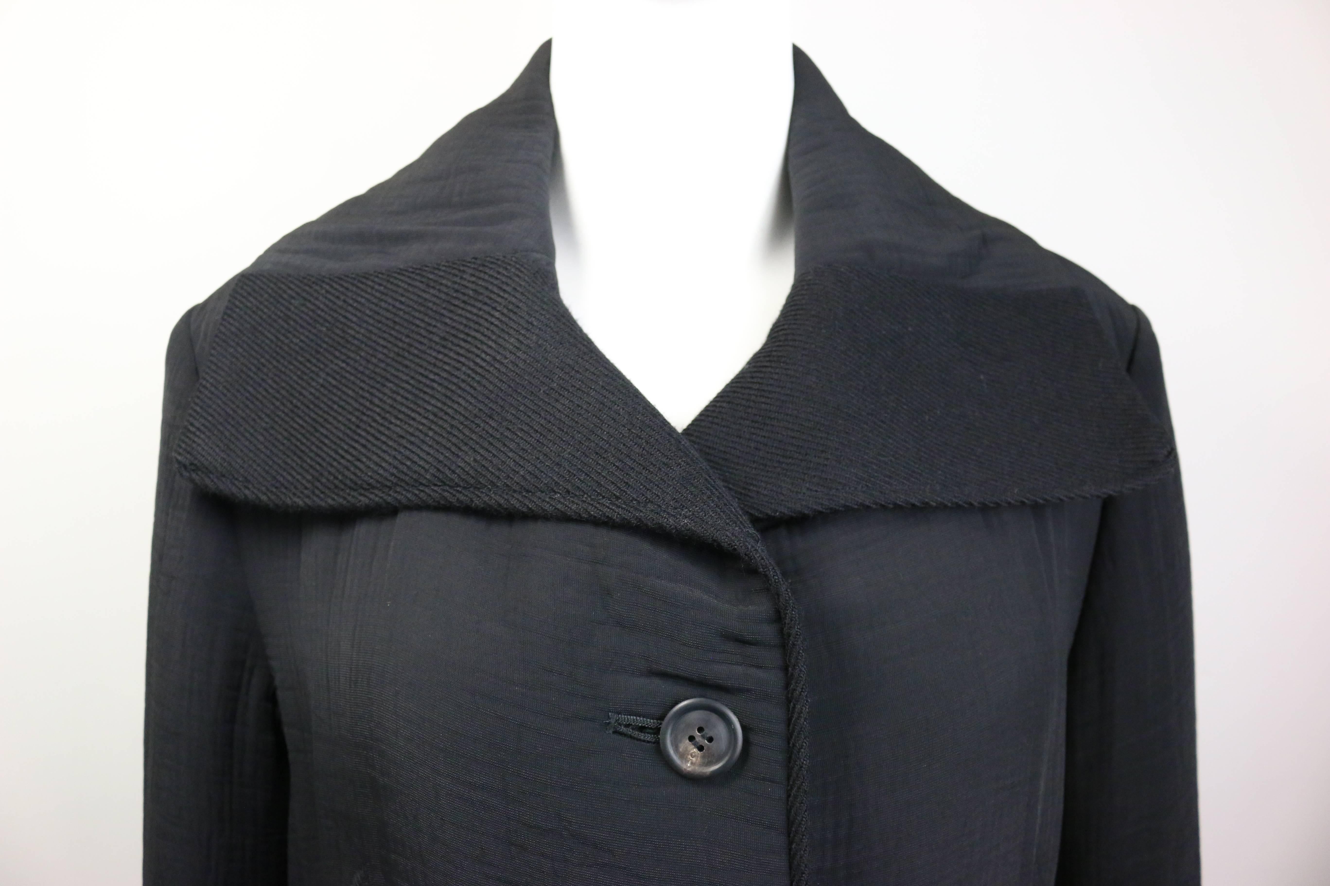- VIntage 90s Issey Miyake black maxi coat. 

- Featuring a black wool wide collar. Six front buttons fastening. Two side pockets. 

- Fully lined. 

- 50% Polyester, 50% Rayon. Collar: 100% Wool. 

- Made in Japan. 

- Size S. 