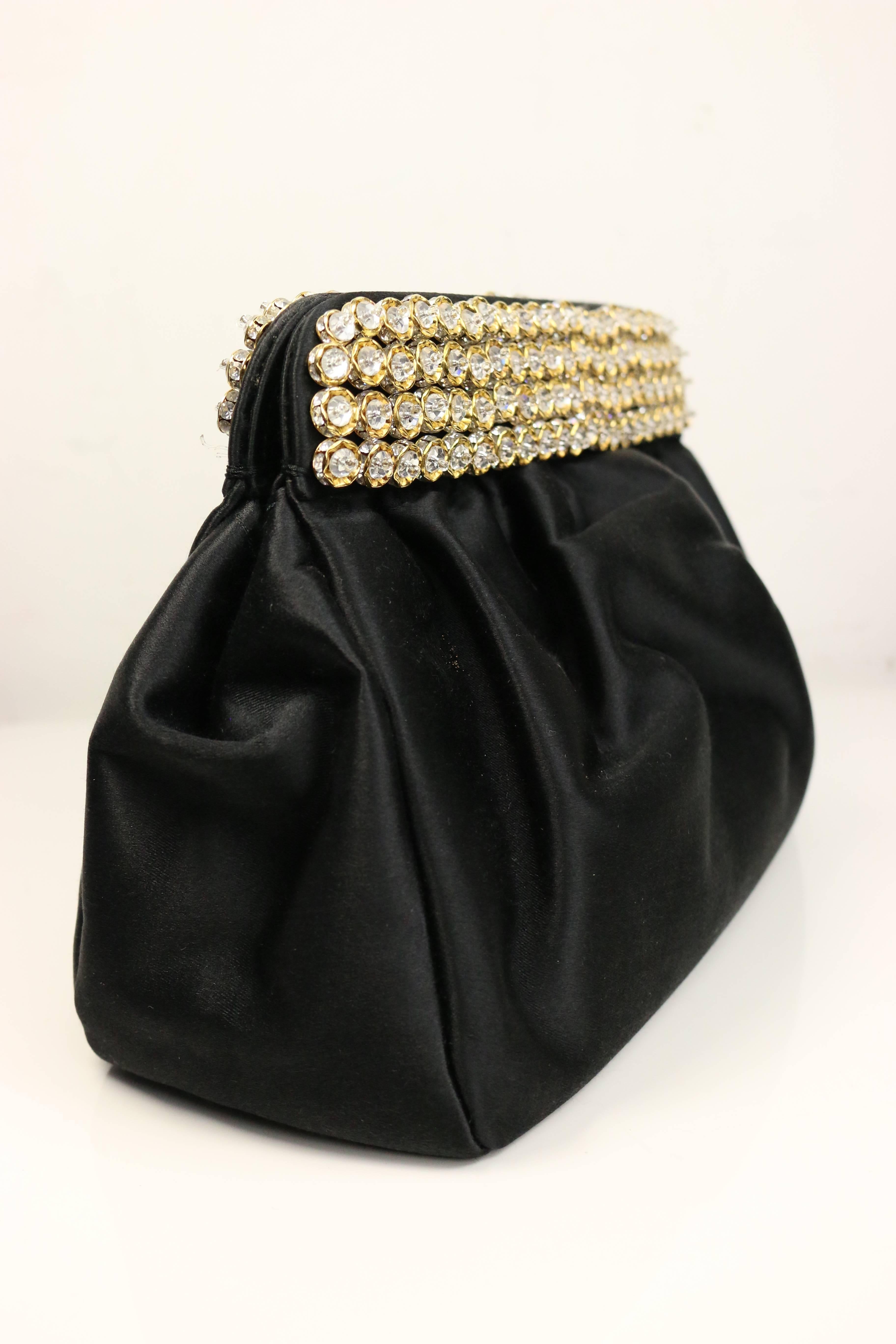 - Vintage 80s Casadei black satin gold toned crystal rhinestones evening clutch. 
This beautiful clutch has a satin strap which can be used as a crossbody bag as well!!! The glamours, elegant and bold are all in one in this bag that represents the