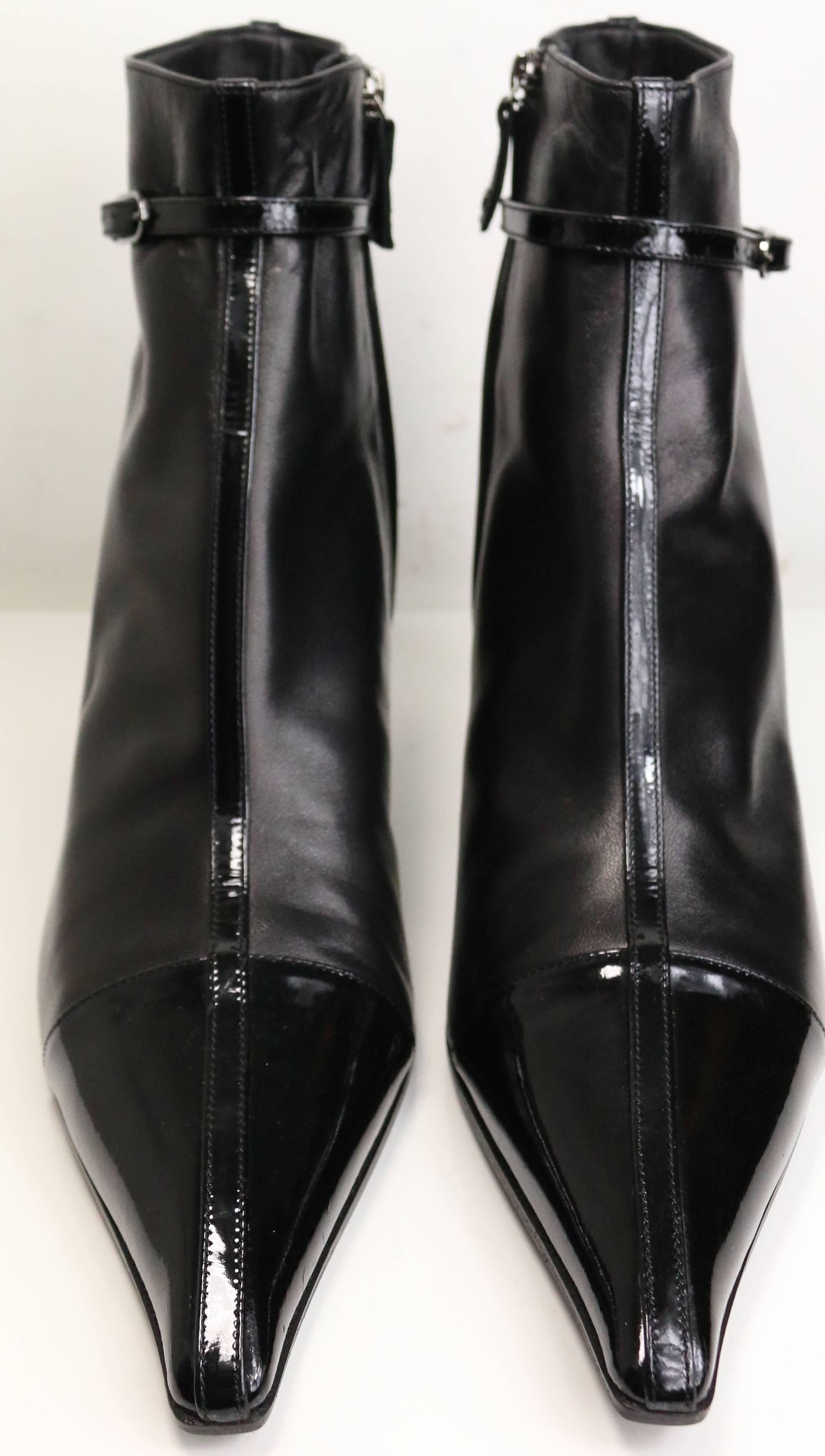 - Chanel black leather pointy ankle boots. 

- Featuring a T-bar patent leather with a 