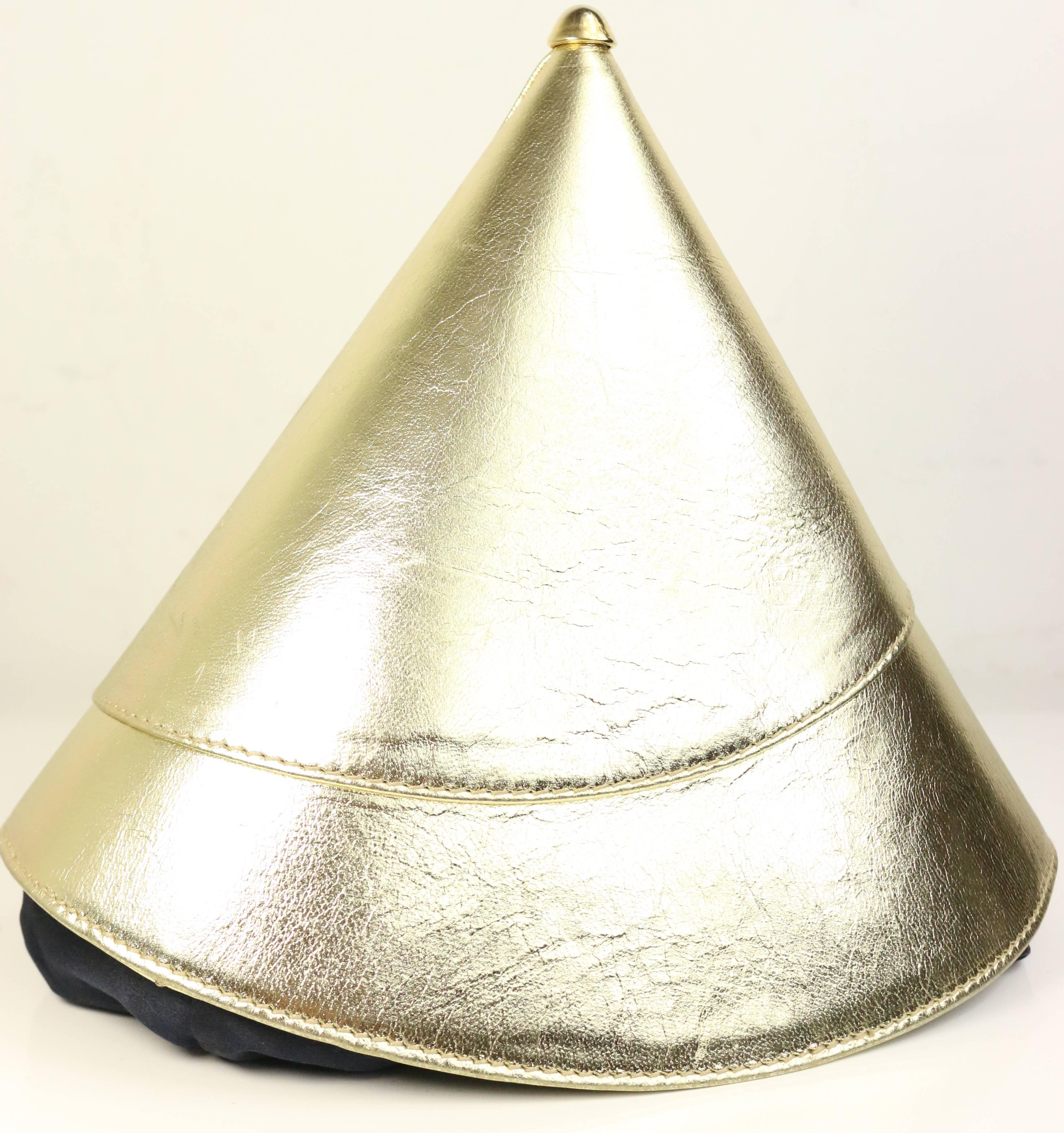 - Vintage 80s Escada gold metallic leather party hat shape handbag. This is a very unique, chic design and one of a kind handbag! You can carry it as a clutch as well.

- Featuring black satin drawstring closing and white/gold stripe lining with