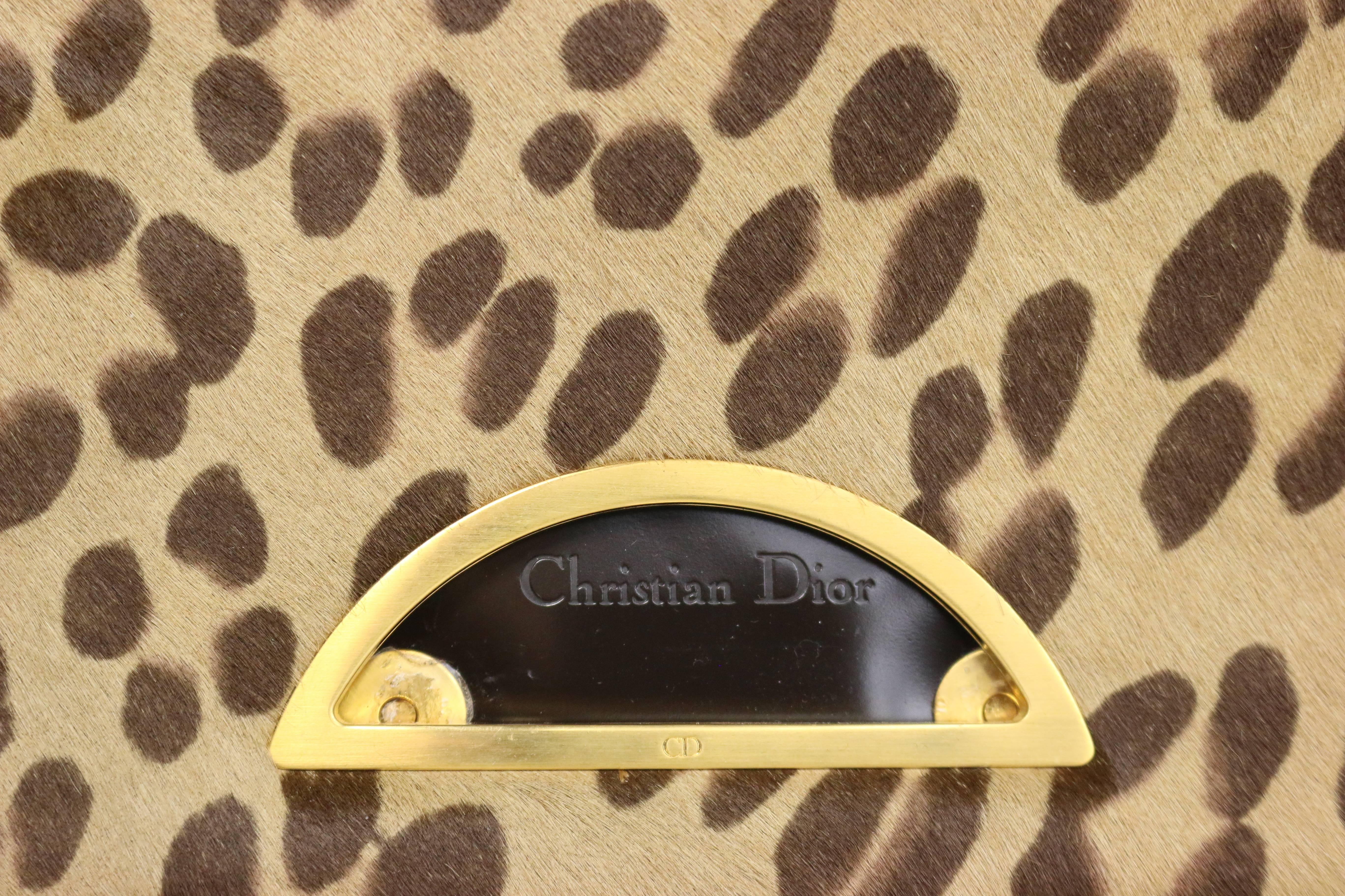 - Christian Dior leopard print pony hair baguette bag with gold tone hardware; Adjustable leather beaded handle; One interior zip pocket; Flap magnetic closure. This bag has never been used before. 

- Made in France. 

- Height with strap: 17