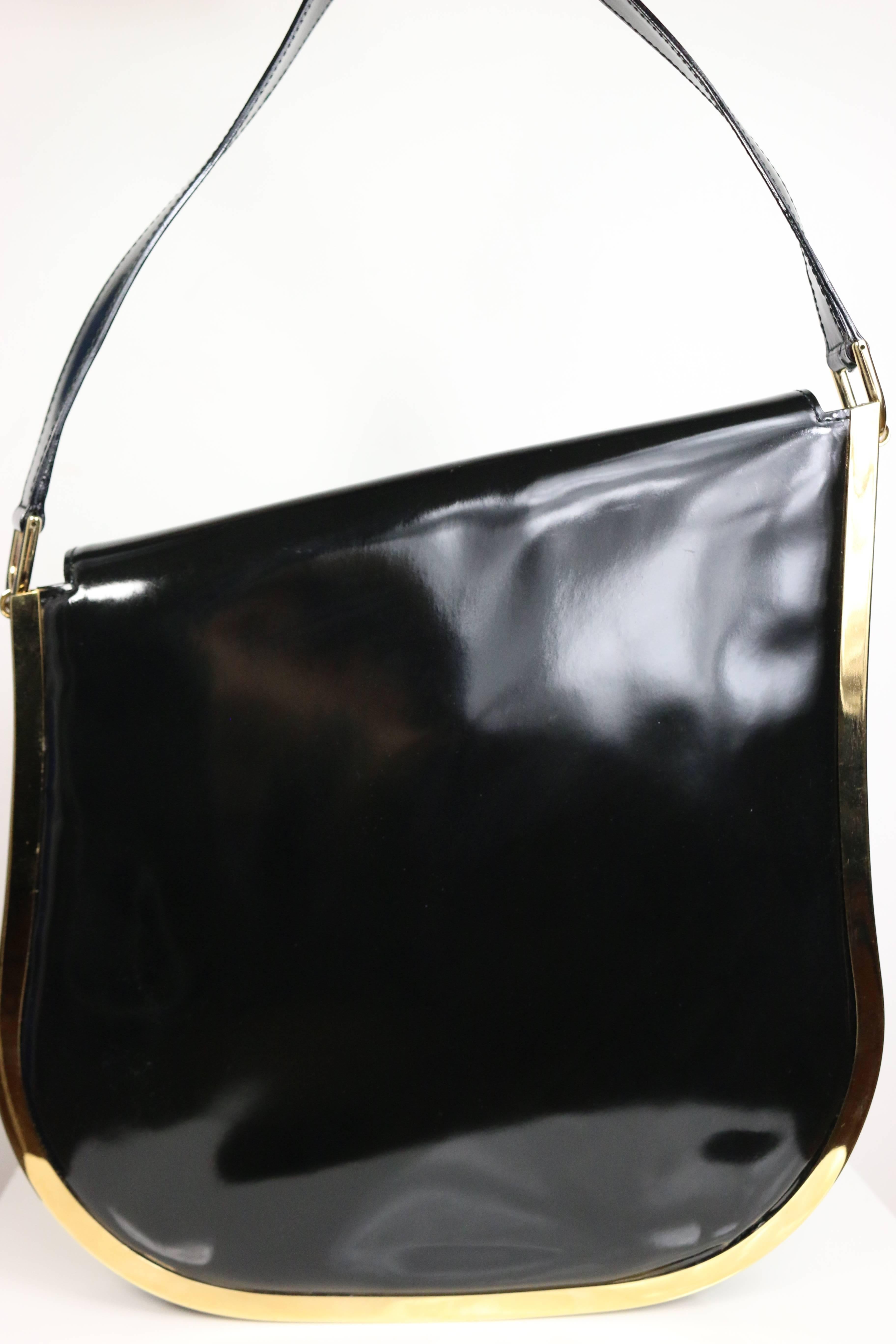 - Gucci by Tom Ford black patent leather gold toned piping shoulder bag from Fall 1996 collection. This bag is a signature of that collection. The slope shape on the top is higher on the left to right fits perfectly around the arms. The base is