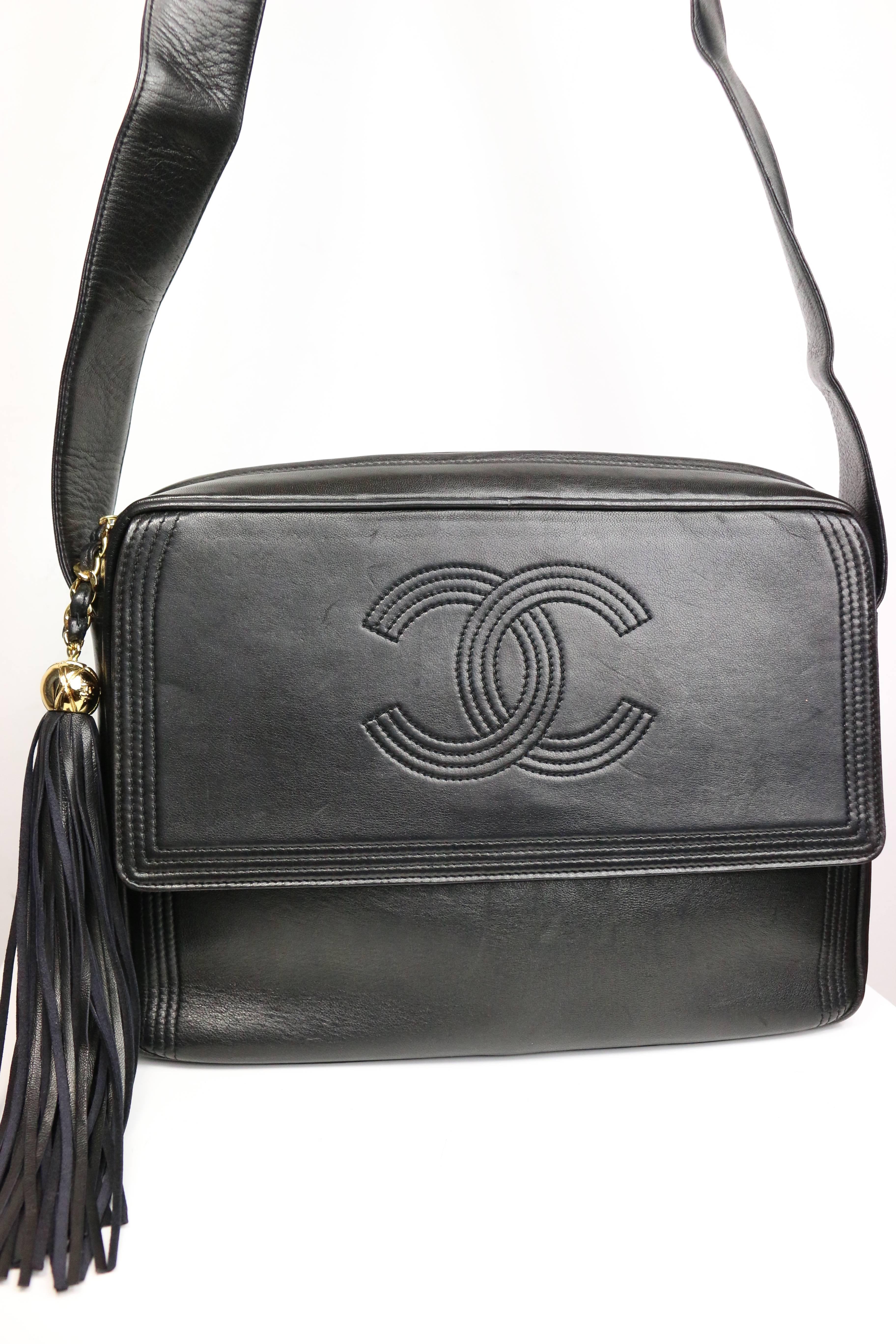 - Vintage 90s Chanel black leather flap bag with tassel. 

- Featuring a 