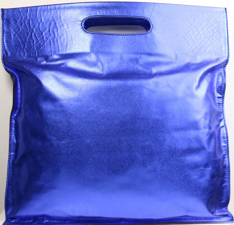 - Vintage 90s Costume National blue metallic leather handle tote bag. Rare colour with shiny surface leather handle tote bag is funky, chic and bold! 

- Made in Italy. 

- Length: 14 inches. Height: 14 inches. 
