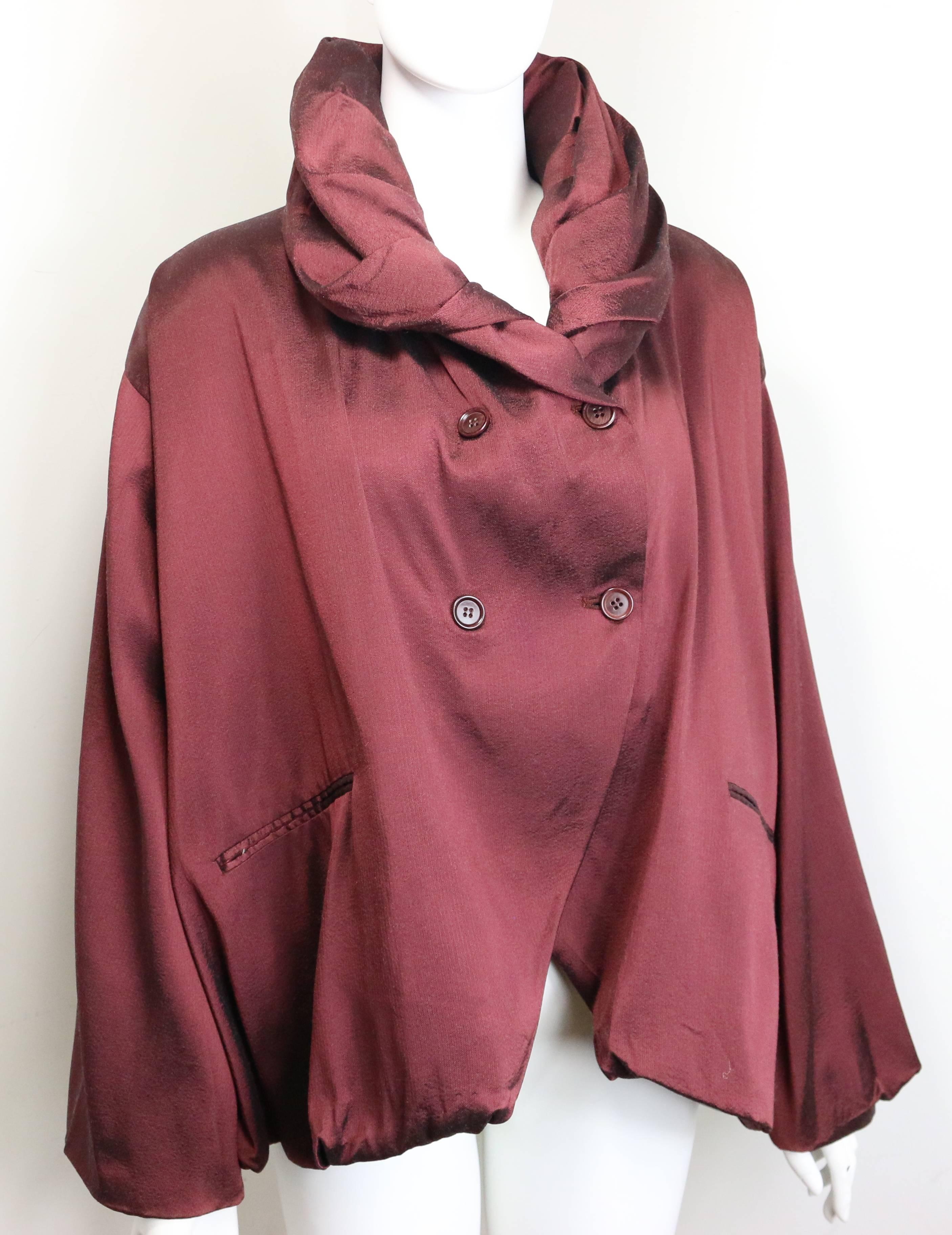 - Vintage 90s Romeo Gigli maroon silk cocoon double breasted coat. Featuring stand up shawl collar which you can fold into different forms. Four buttons closure. Two welt pockets. This is Romeo's  signature style which is romantic, dropped shoulders