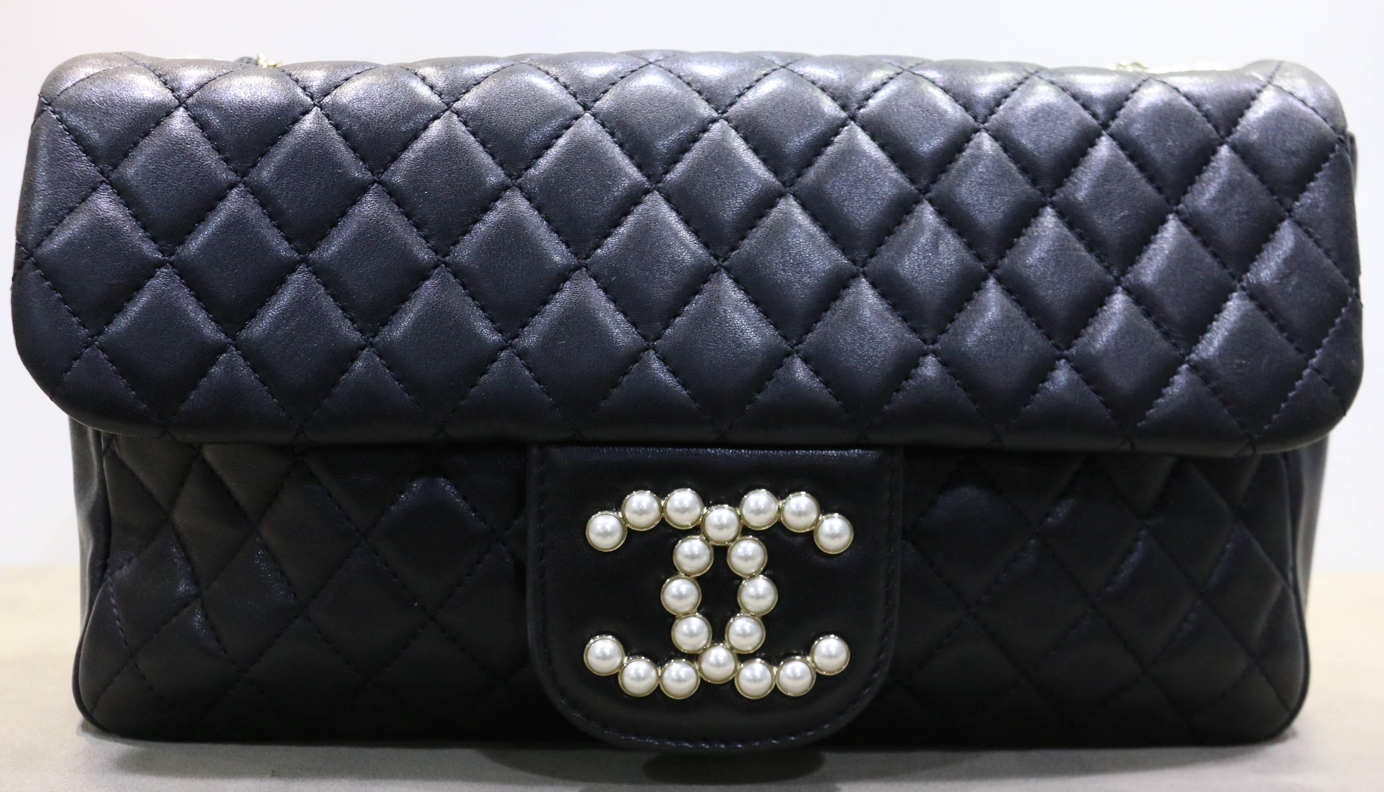 - Chanel black lambskin westminster quilted pearl medium flap bag . 

- Featuring  pearl, small chain and large chain shoulder straps and a cross over flap with a Chanel CC Mademoiselle faux turn lock.

- Length: 10 inches. Height: 6 inches.