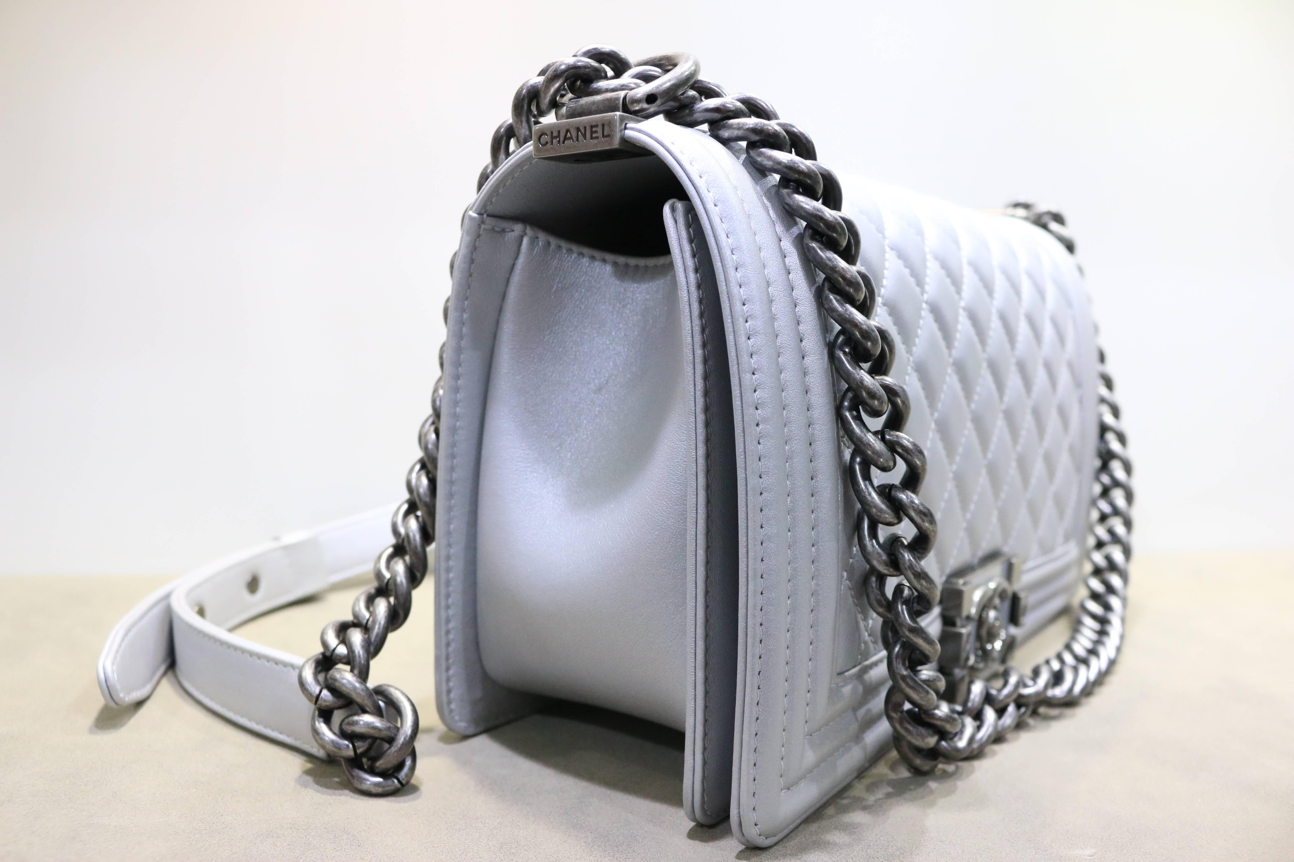 - Chanel silver metallic calfskin quilted medium boy flap bag with ruthenium chain link shoulder straps. Its brand new and never been used before!!!

- Made in Italy. 

- Length: 10 inches. Height: 6 inches. Depth: 3 inches. Strap Drop: 20
