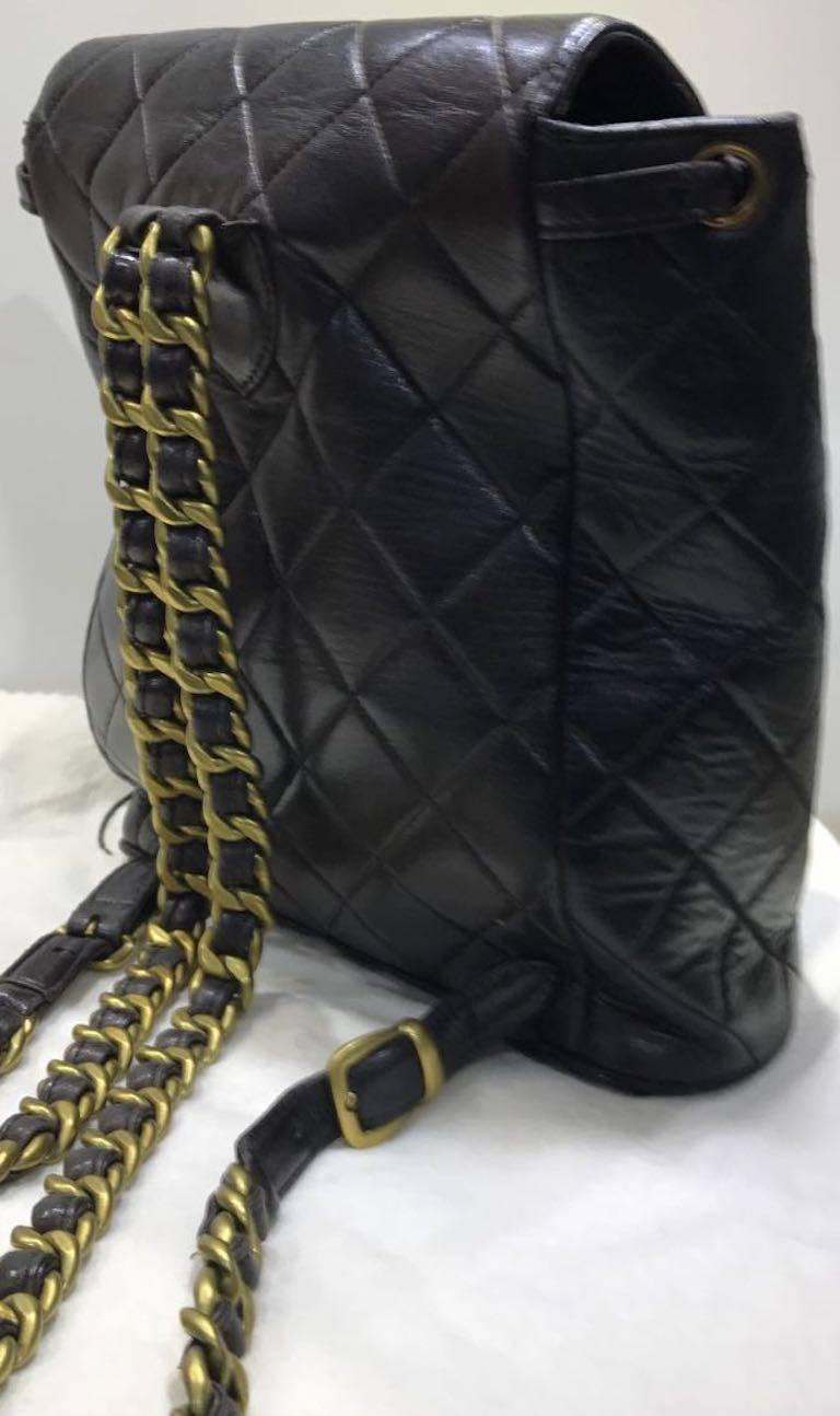 - Vintage 90s Chanel black quilted lambskin leather backpack with gold chain. 

- Featuring rusty gold tone color chain straps and golden CC closures at front closures with "CC" stitches logo on the bottom. 

-  Made in France. 

- Height: