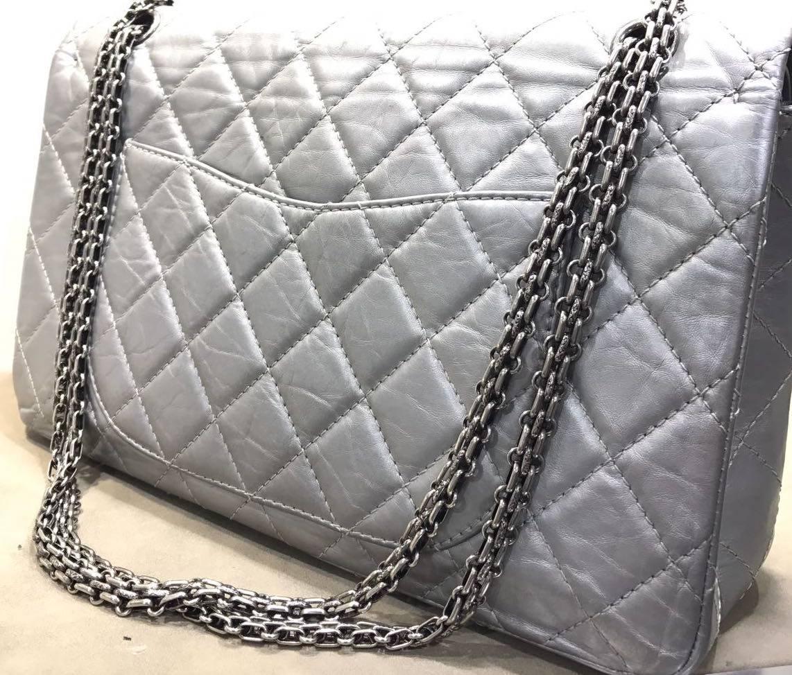 -  Chanel silver aged calfskin leather quilted 2.55 double flap bag. This Flap features a rectangle ruthenium turn-lock closure and reissue silver chain. This bag is in good preowned condition. 

-  Made in France. 

- Measurements: 12.5" L x