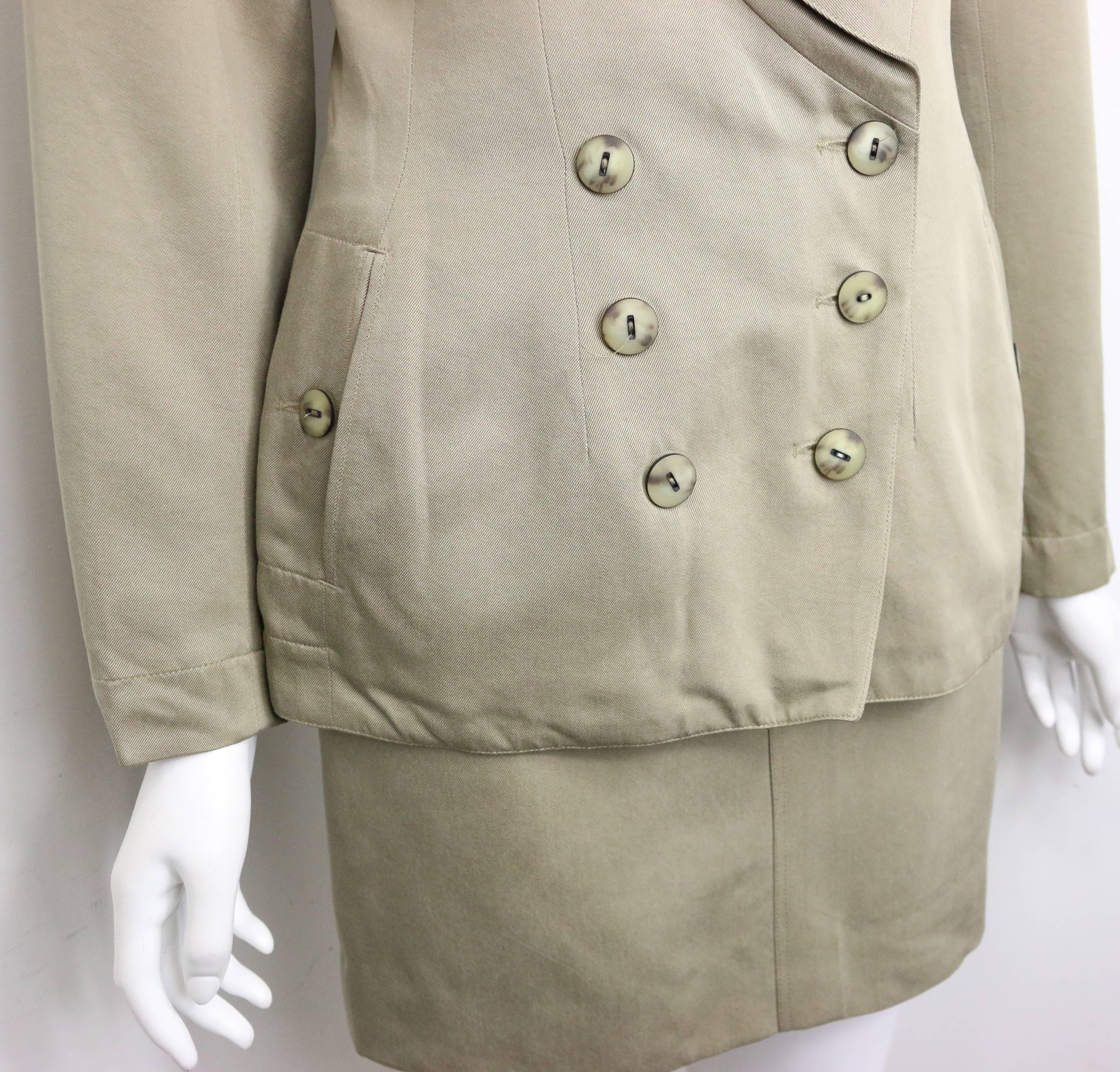 - Vintage 90s Alaia Khaki double breasted jacket and skirt ensemble. Featuring six front buttons closure, two side pockets with one button closure on each. Skirt has two front pockets with button closure and one back pocket button closure. 

- Made