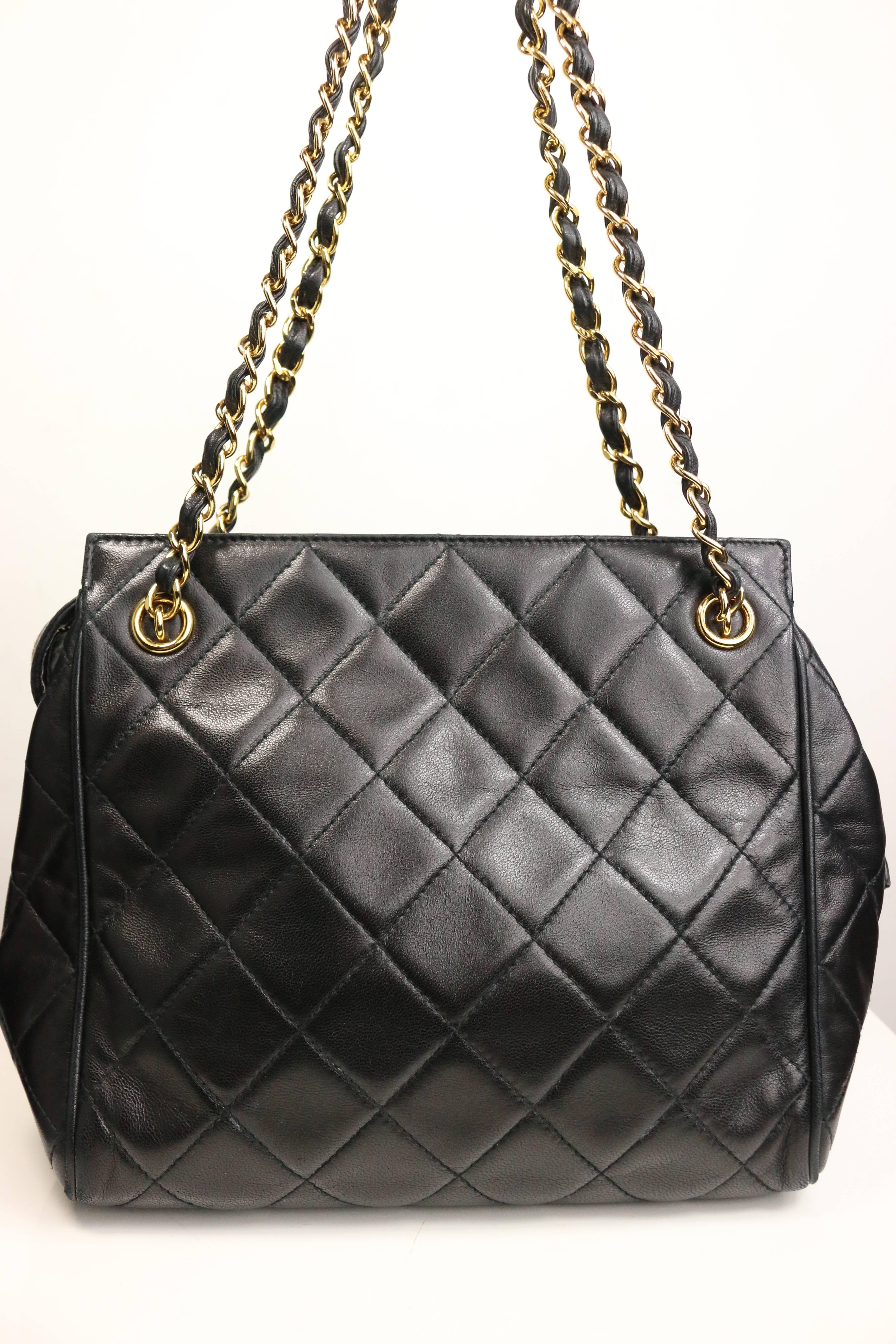 - Vintage 90s Chanel black quilted lambskin leather petite timeless shoulder strap tote. Featuring a gold toned leather chain double straps and a snap button with gold toned "Chanel" zipper closure. The interior has one zipper pocket and