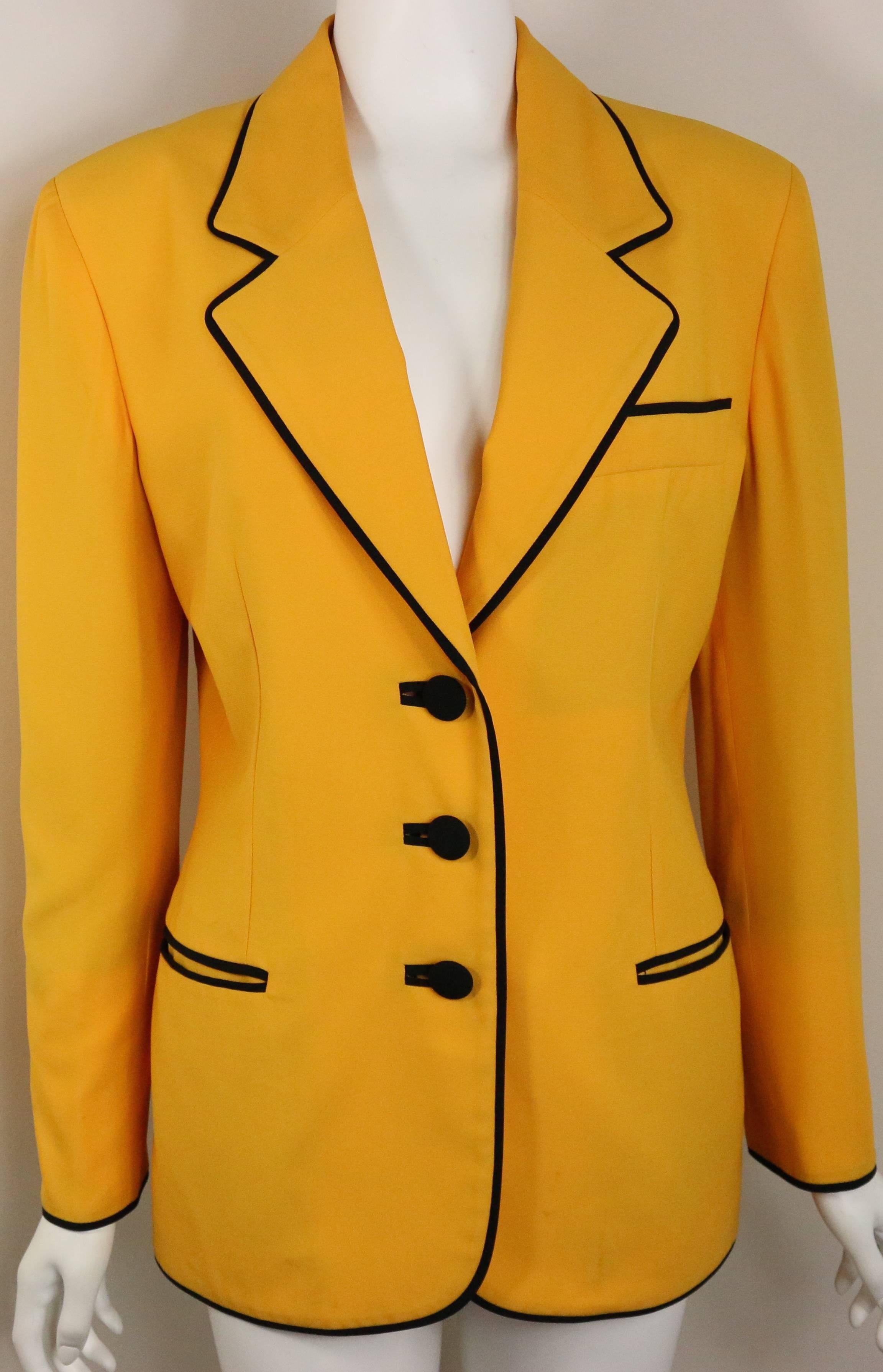 - Vintage 90s Moschino Couture yellow black piping blazer with iconic black "smiley" face displayed at the back. 

- Featuring black piping with three front black buttons fastening.  Four black buttons on each cuff. 

- Made in Italy. 

-