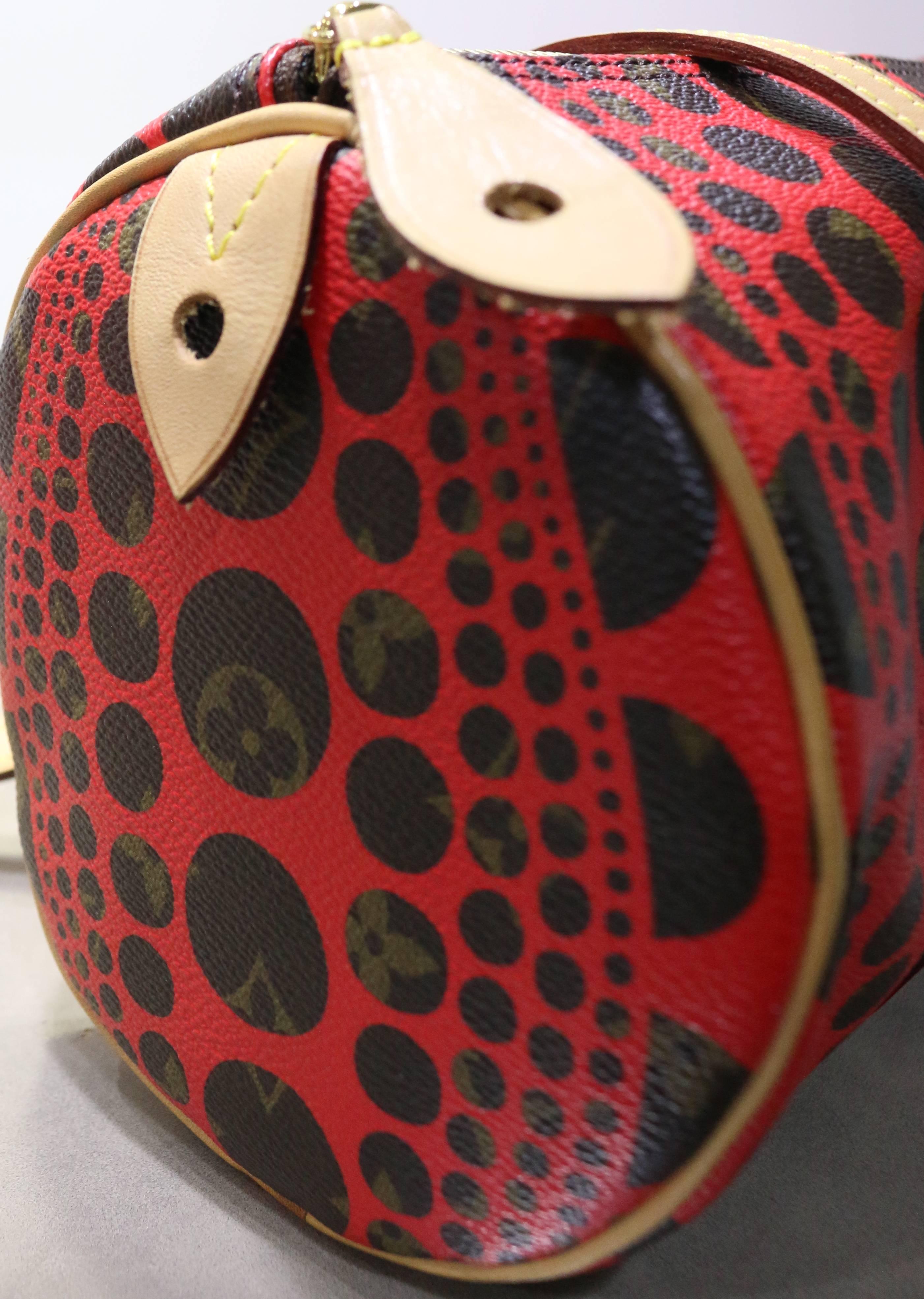 -This funky and chic Louis Vuitton x Yayoi Kusama red monogram canvas pumpkin dots pavilion bag is a year 2012 limited edition. Yayoi is known in the art world for her obsession with dots. Featuring a gold toned hardware single zipper fastening and