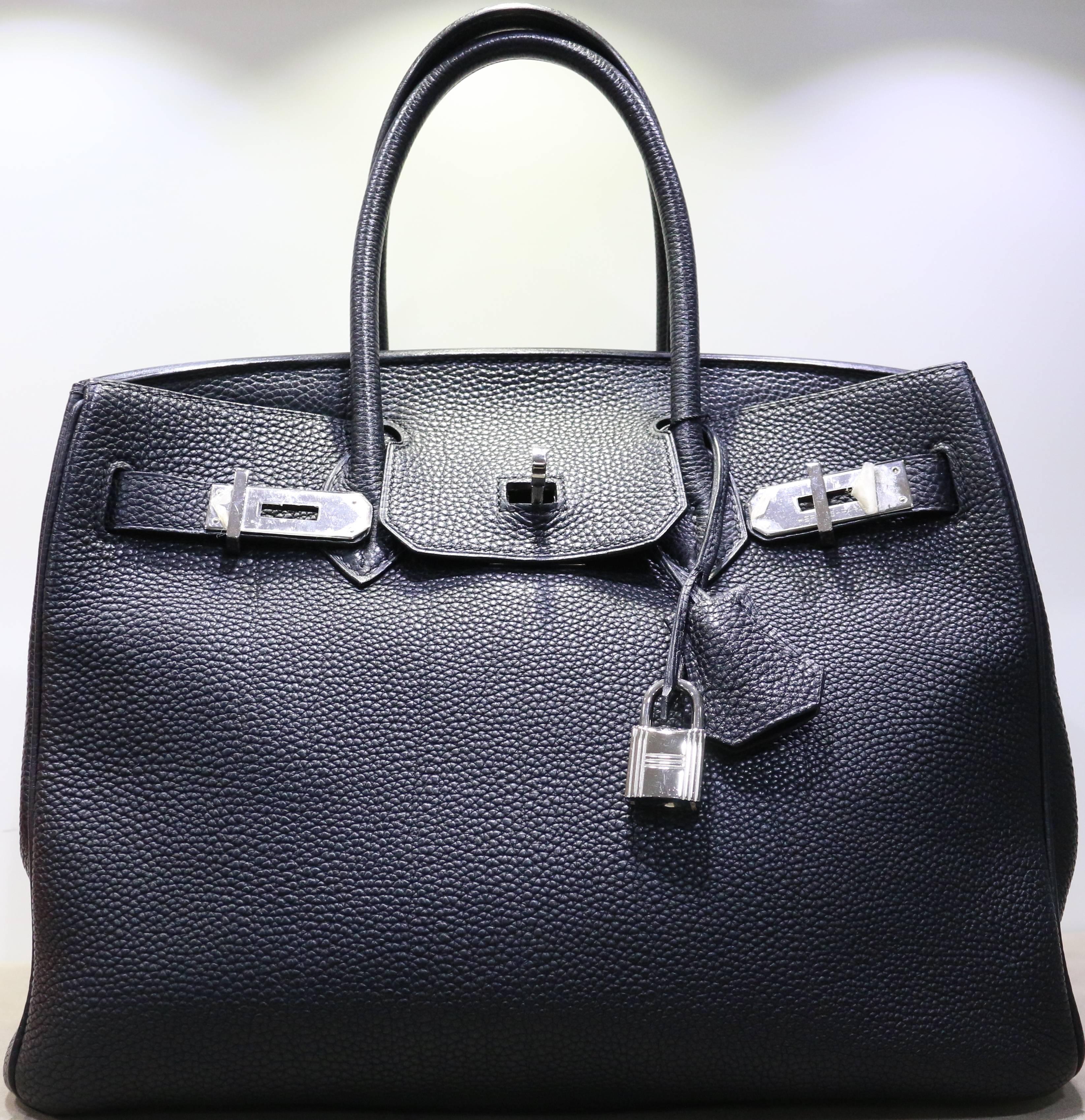 - This Authentic Hermes black Birkin 30cm in togo leather with silver hardware is chic, elegant and classic and timeless. The bag is in excellent preowned condition. 

- Interior pockets: 1 open, 1 zippered. 

- Made in France. 
 
- Measurements: