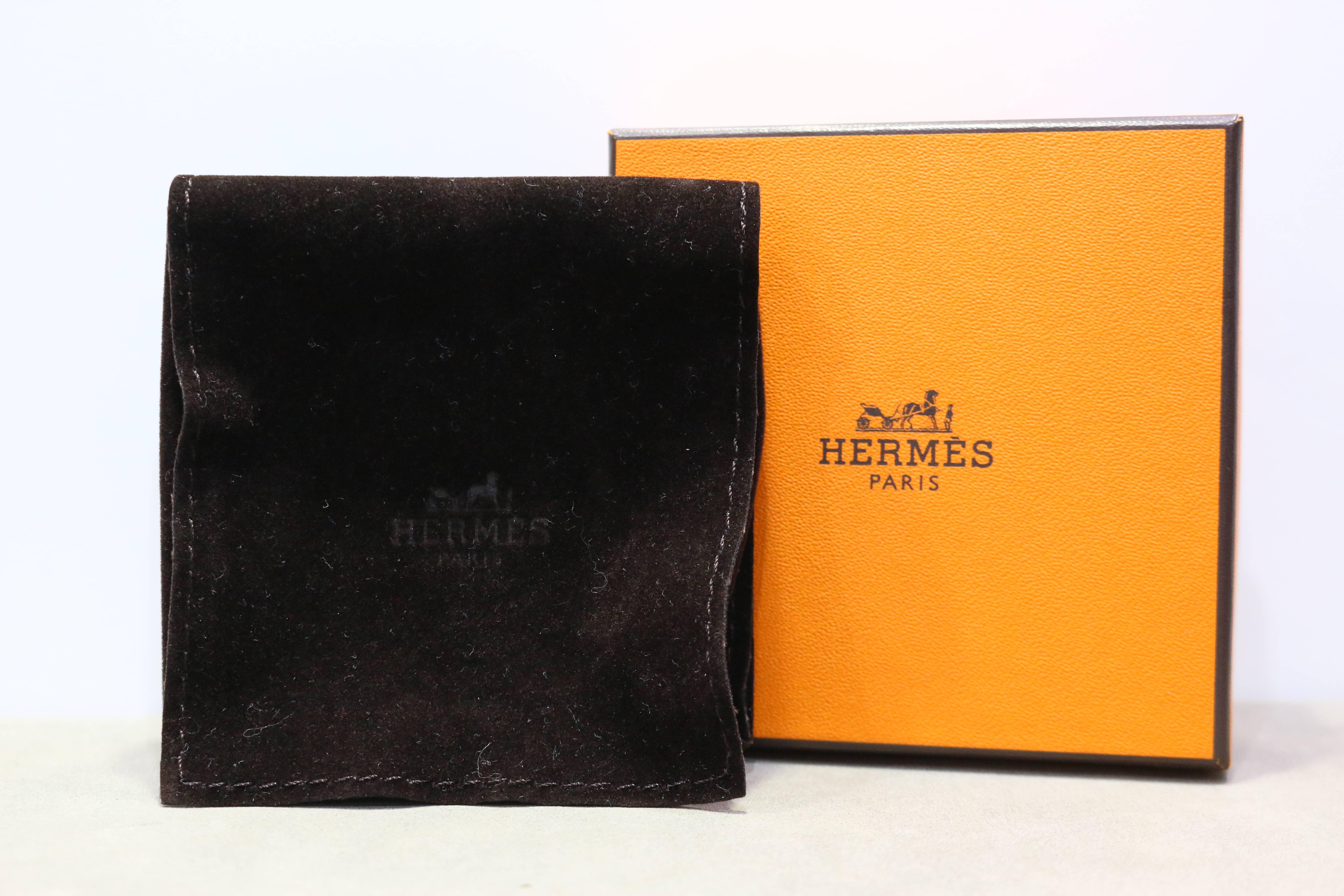 - Authentic and brand new Hermes orange Kelly double tour leather bracelet in silver toned hardware. It is a classic leather bracelet with a sense of chicness! 

- Made in France. 

- Measurement: 37.5 cm 

- It comes with dust bag and original box.