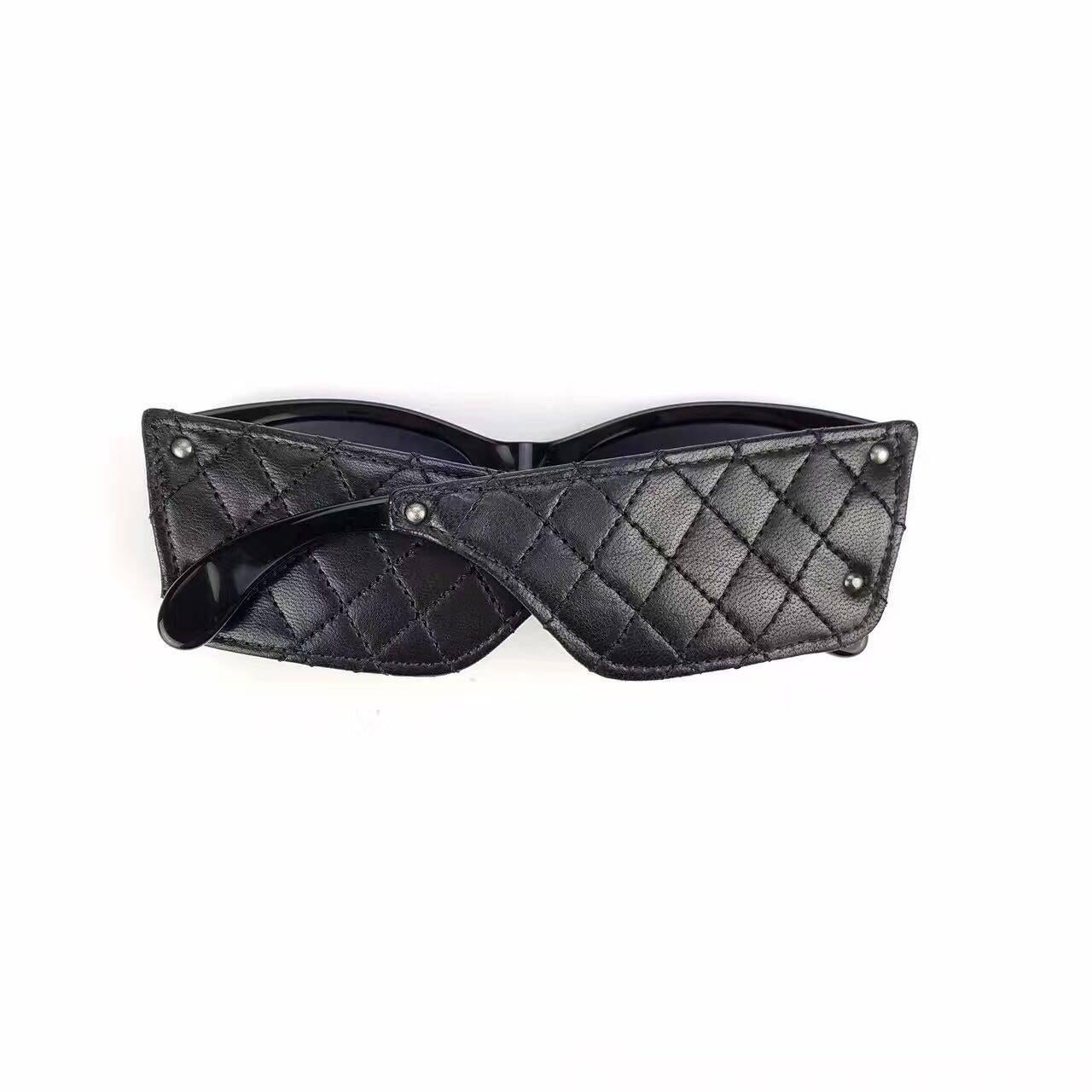 - Vintage Chanel black leather sunglasses with wild quilted details on the side from year 1988.  

- Made in France. 

- Measurement: Frame width 5.8 inches. Temple/ Side Arm Height: 1 5/8 inches. 

- Include: Original case. 

- Please note this