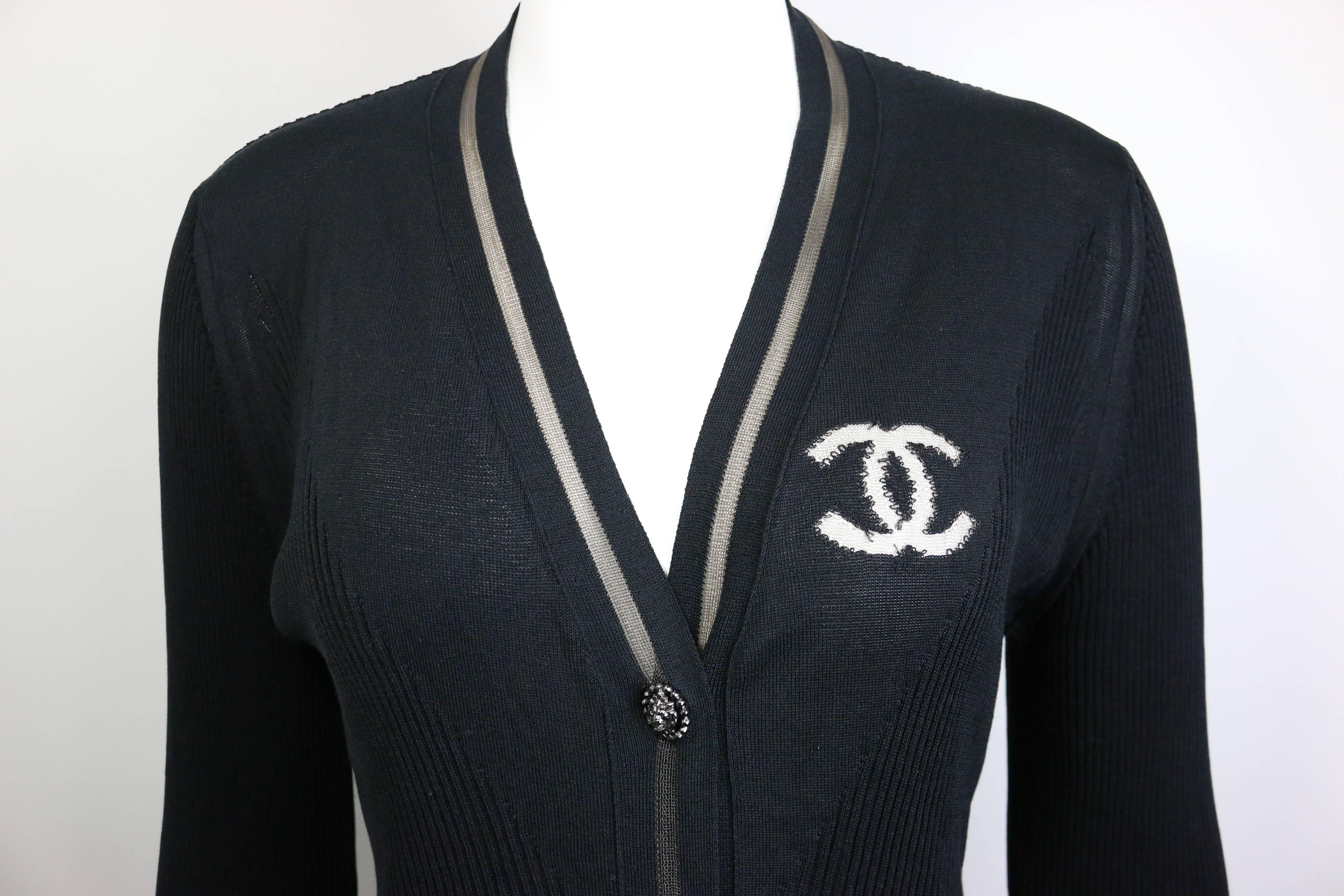 - Chanel black stripe cotton and silk long cardigan. Featuring mesh "CC" logo on the left front and shawl neck mesh trim with five front silver "Lion" buttons closure. Two side pockets with silver "Lion" buttons. This