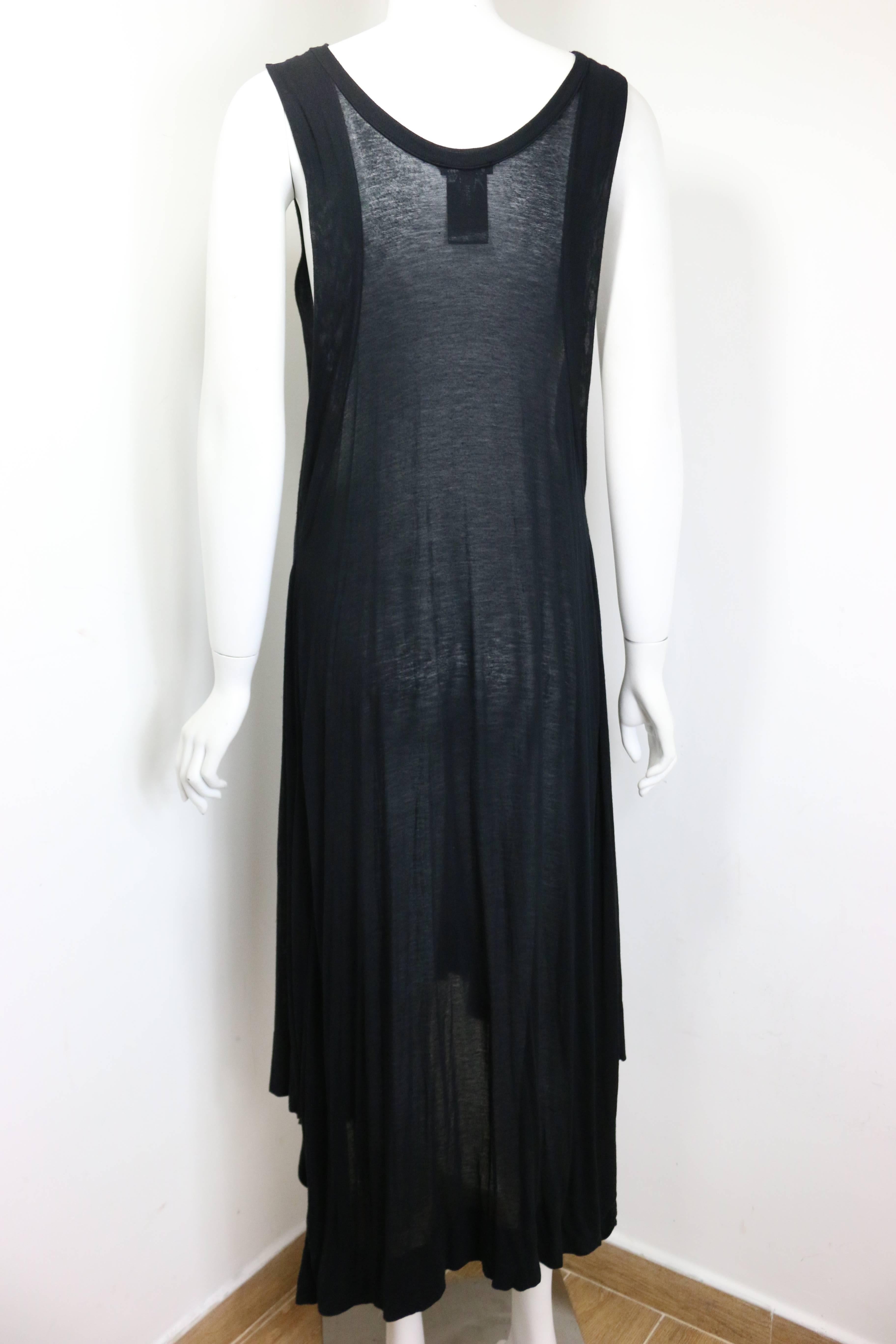 - Ann Demeulemeester black asymmetrical long dress. Featuring medium weight see through fabric with asymmetrical hem. Her signature style has always been consistently dark with a rock and roll touch in it. Timeless and unique! 

- Made in Italy. 

-