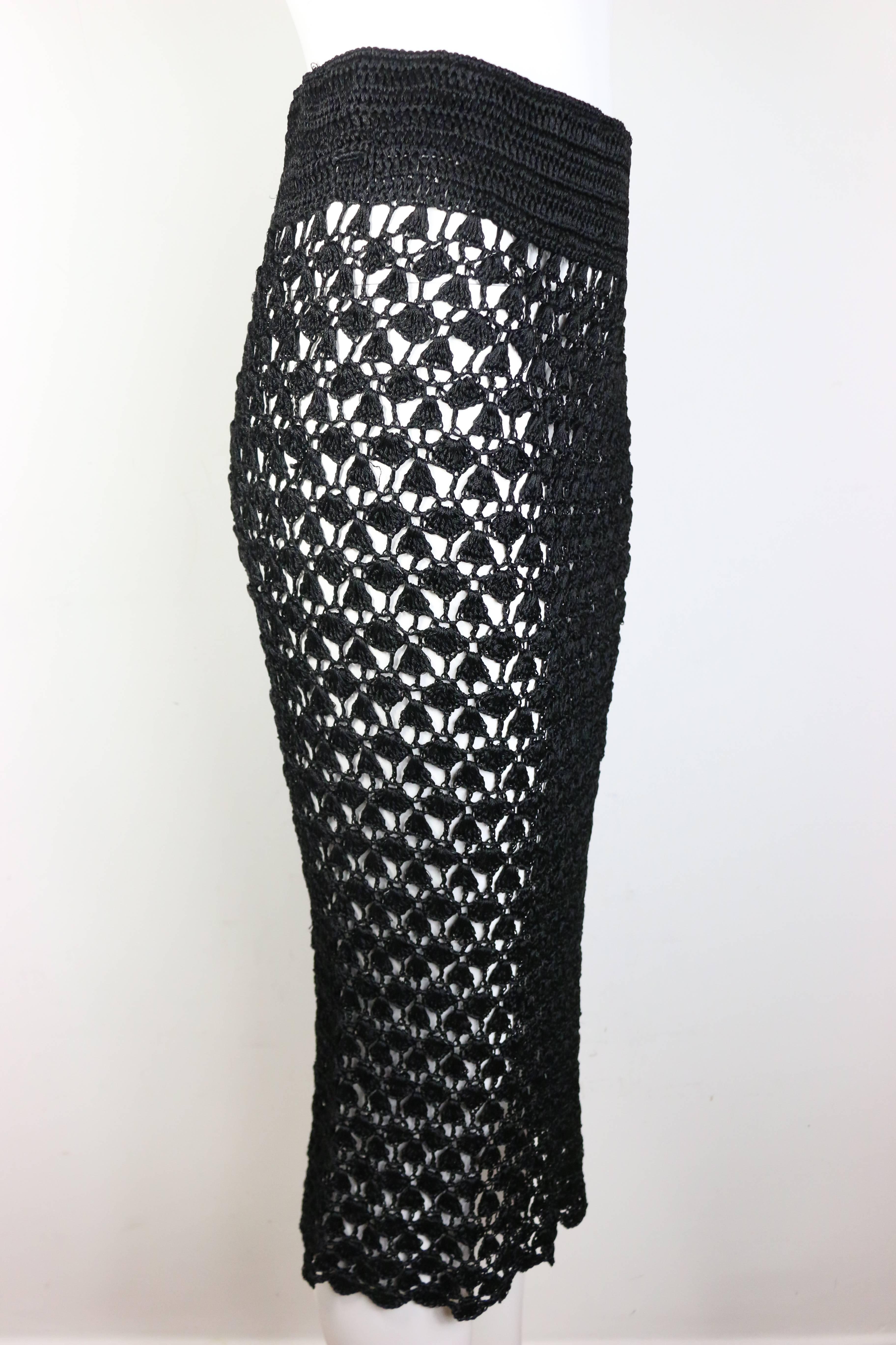 - Vintage 90s Dolce and Gabbana black handmade knitted knee length pencil skirt. This handmade item is very rare and precious.  Featuring side zipper closure and a satin lining for the waistline. One of a kind!

- Made in Italy. 

- Size M. 

- 100%