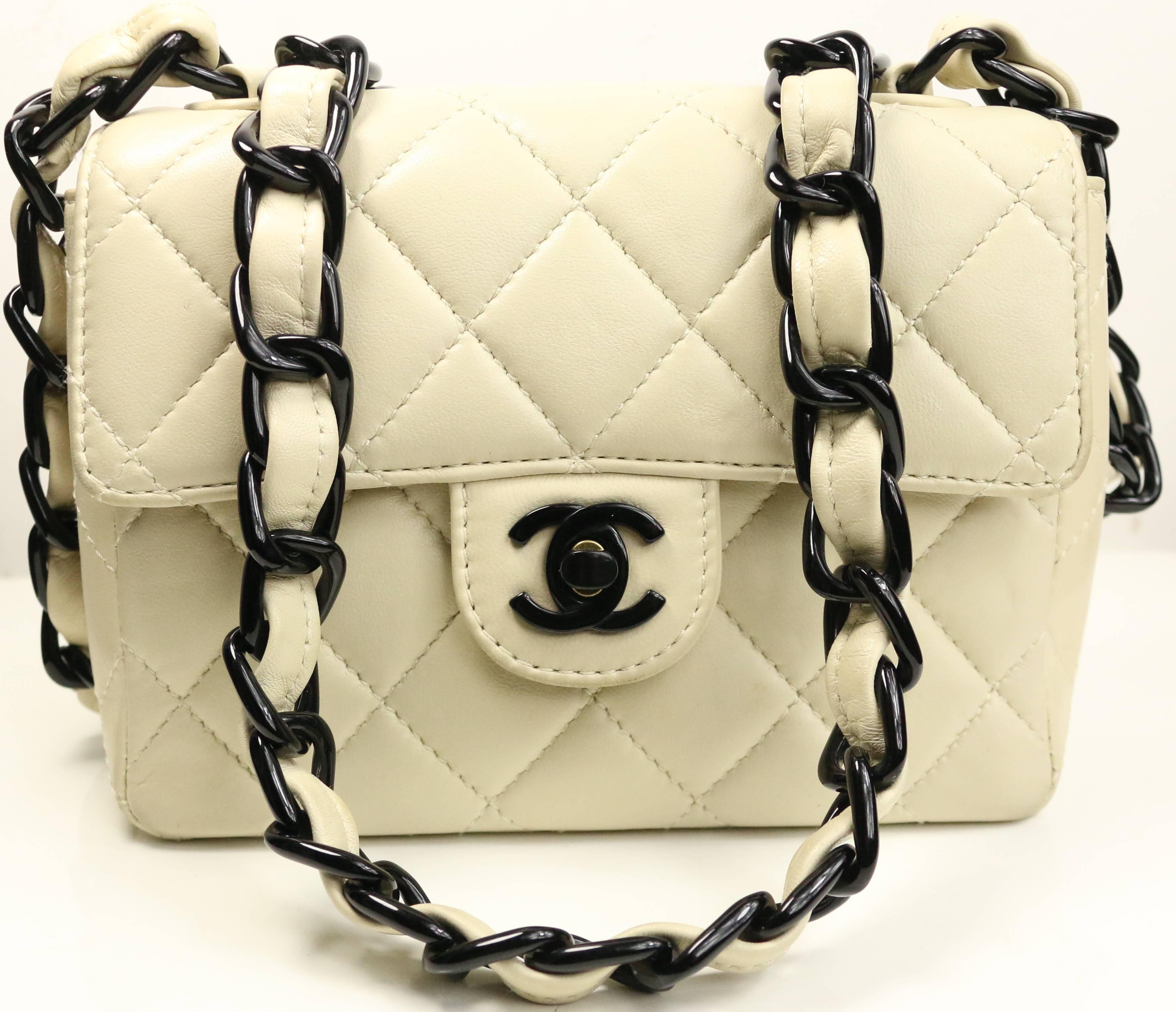- Vintage 90s Chanel vanilla quilted lambskin leather with black vinyl chain strap leather mini flap bag. This classic quilted leather bag can be worn as cross body or shoulder. Signature black turn lock is made of vinyl. Featuring a back pocket and