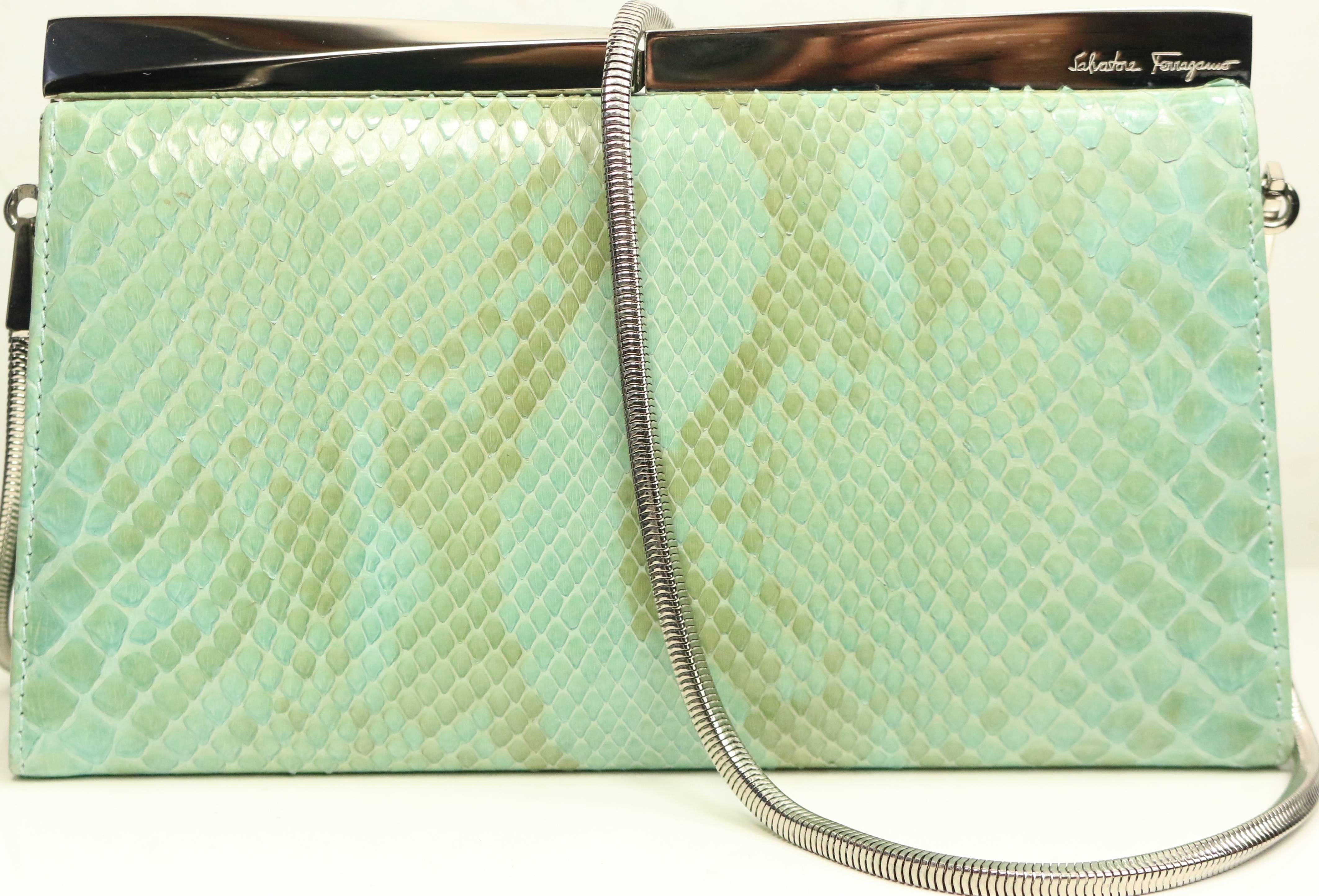 - Vintage 90s Salvatore Ferragamo green python clutch with silver toned detachable shoulder strap. Featuring an interior zipper pocket. This erotic python clutch is suitable for causal daily use or an evening night out.

- Made in Italy. 

- Length: