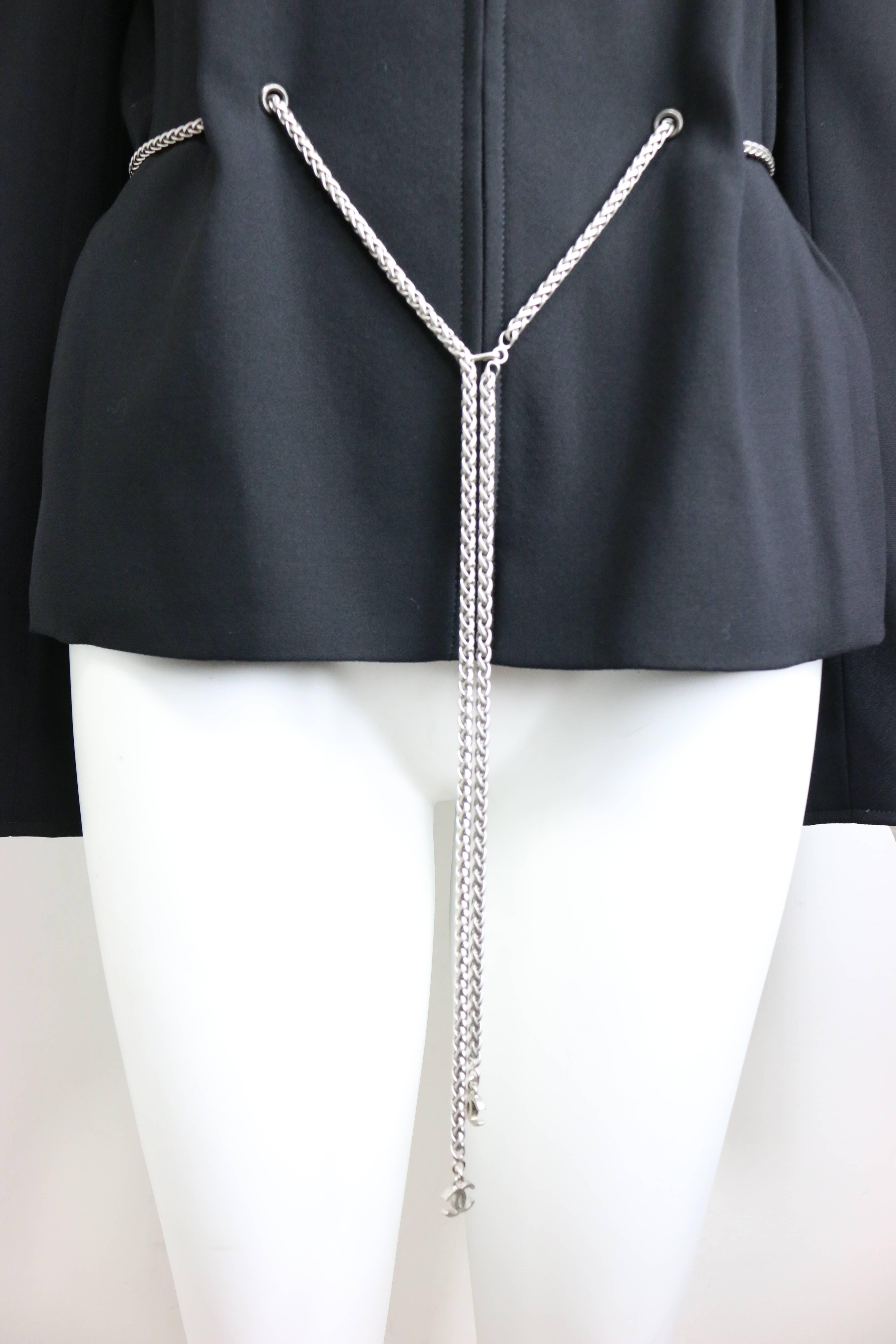 - Vintage Chanel black wool waist chain collarless jacket from 1998 pre-collection. Featuring a silver toned chain connects throughout the waistline with two 