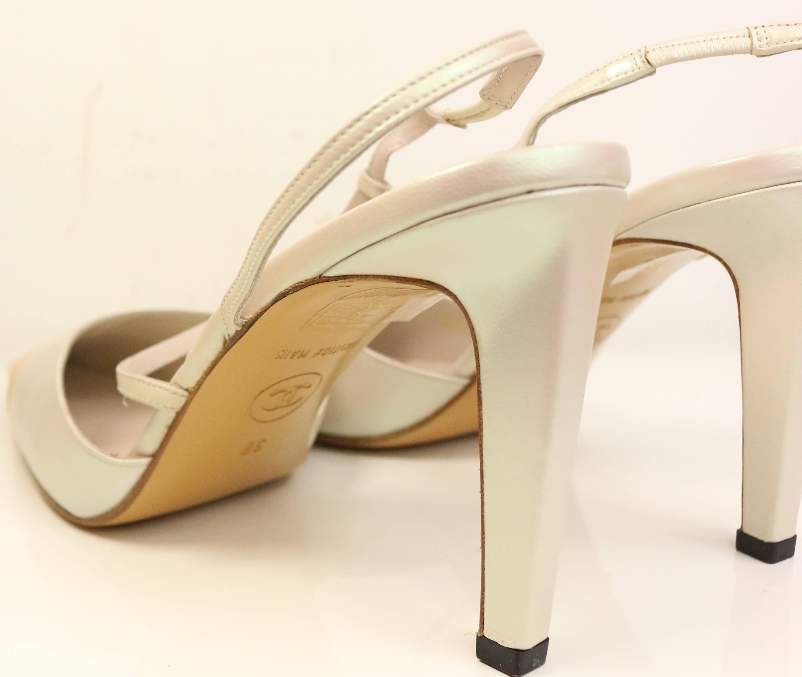 - Vintage Chanel bi toned ivory pearl/salmon leather pointy slingback heels. Featuring a coated 