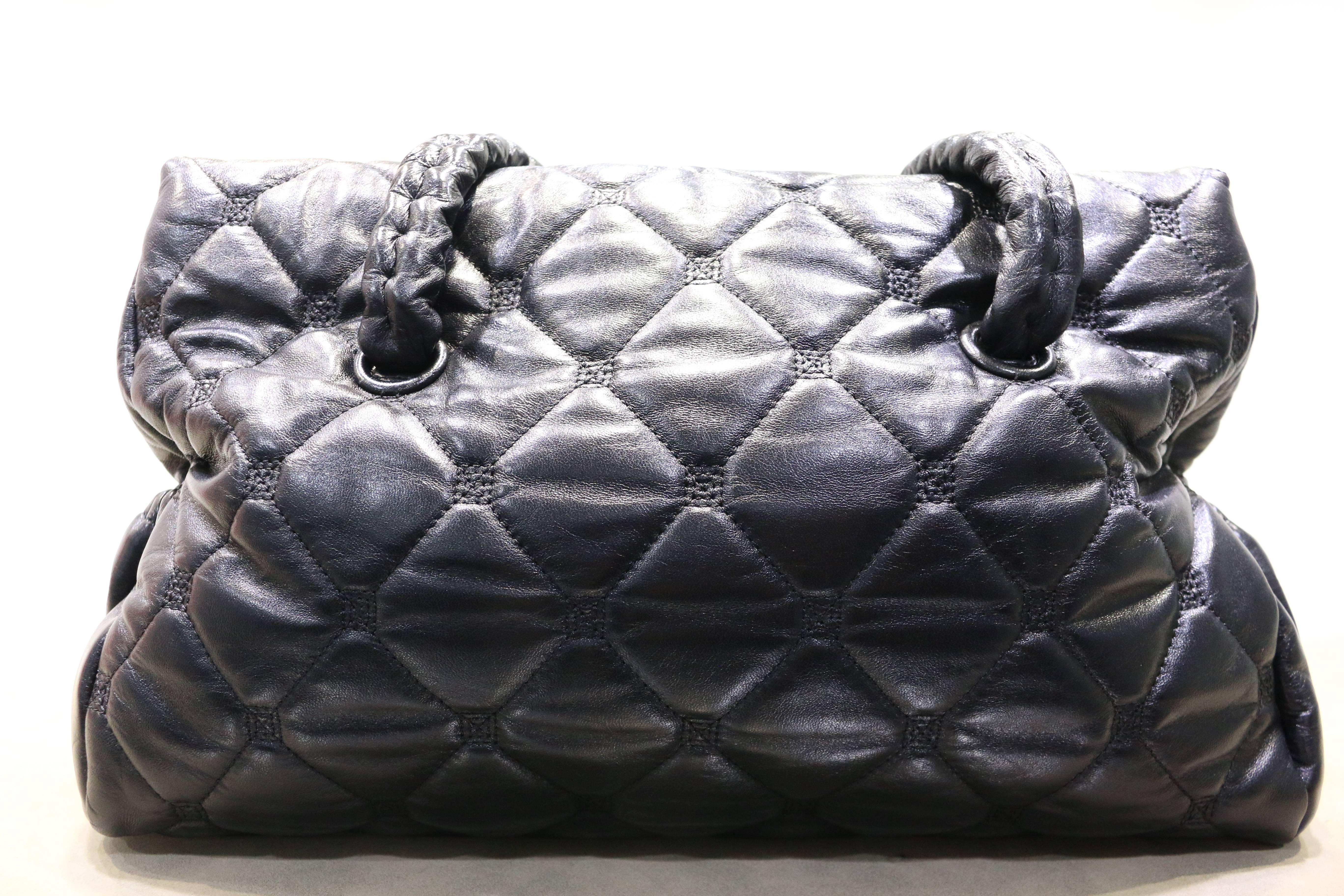 - Chanel black quilted textured lambskin leather double straps handbag from year 2008 to 2009. Featuring two side pockets with a silver satin leather interior and zipper pocket. 

- Made in Italy. 

- Length 37cm x Height 23cm x Width 15cm. Handle: