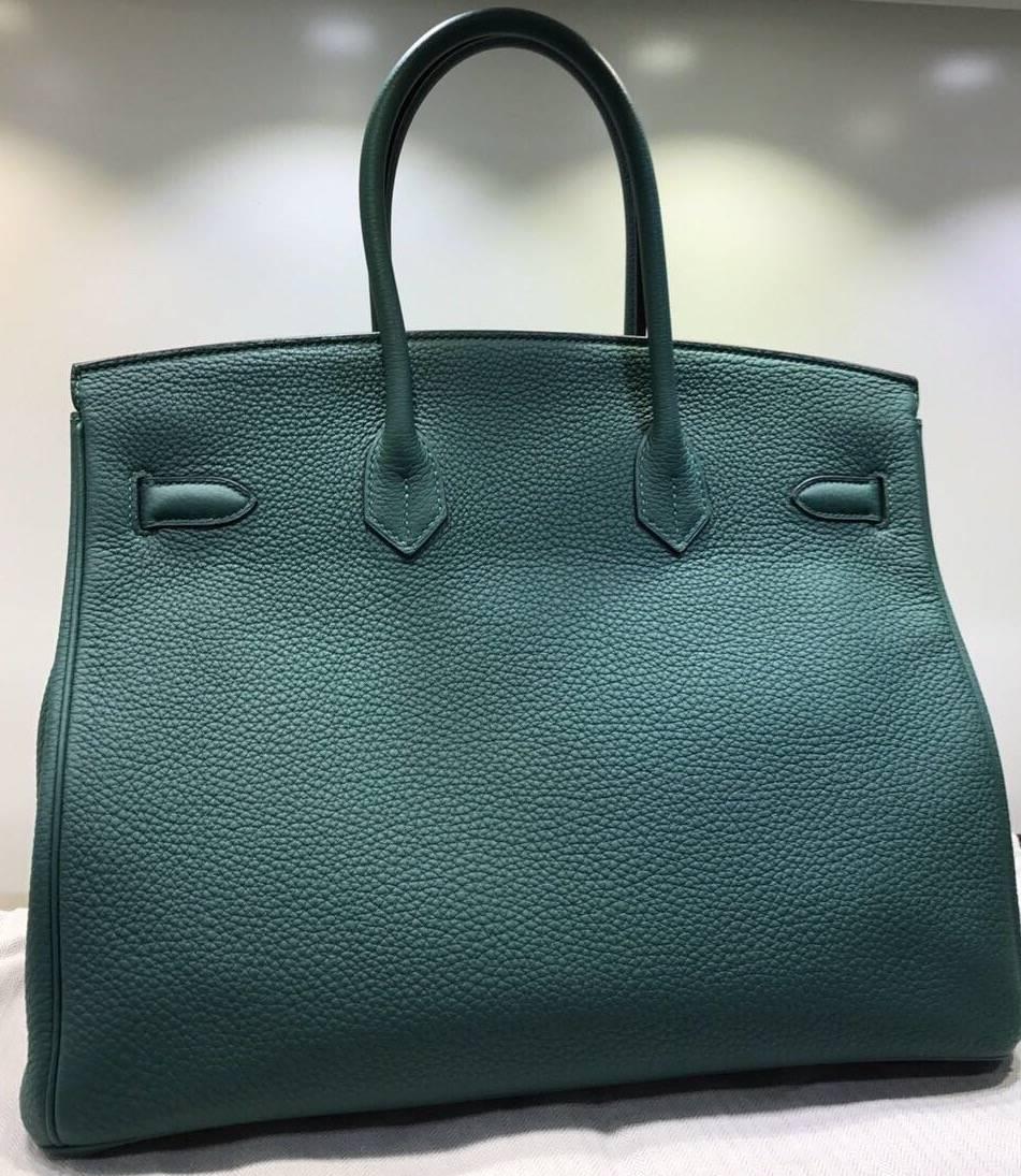 - Hermes Malachite Birkin 35cm togo leather with silver hardware from year 2012 . Featuring all the usual Birkin hardware such as tonal stitching, front toggle closure, clotted lock with keys and double rolled handles.  This dark green Birkin is one