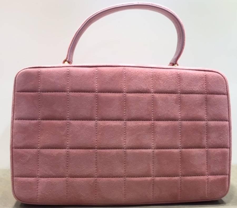- Vintage 2000s Chanel pink quilted handbag in suede leather. Featuring a front flap closure, gold toned logo turncock fastening and a single handle. Leather interior with a zipper pocket and an open pocket. Such a cute and lovely small handbag for