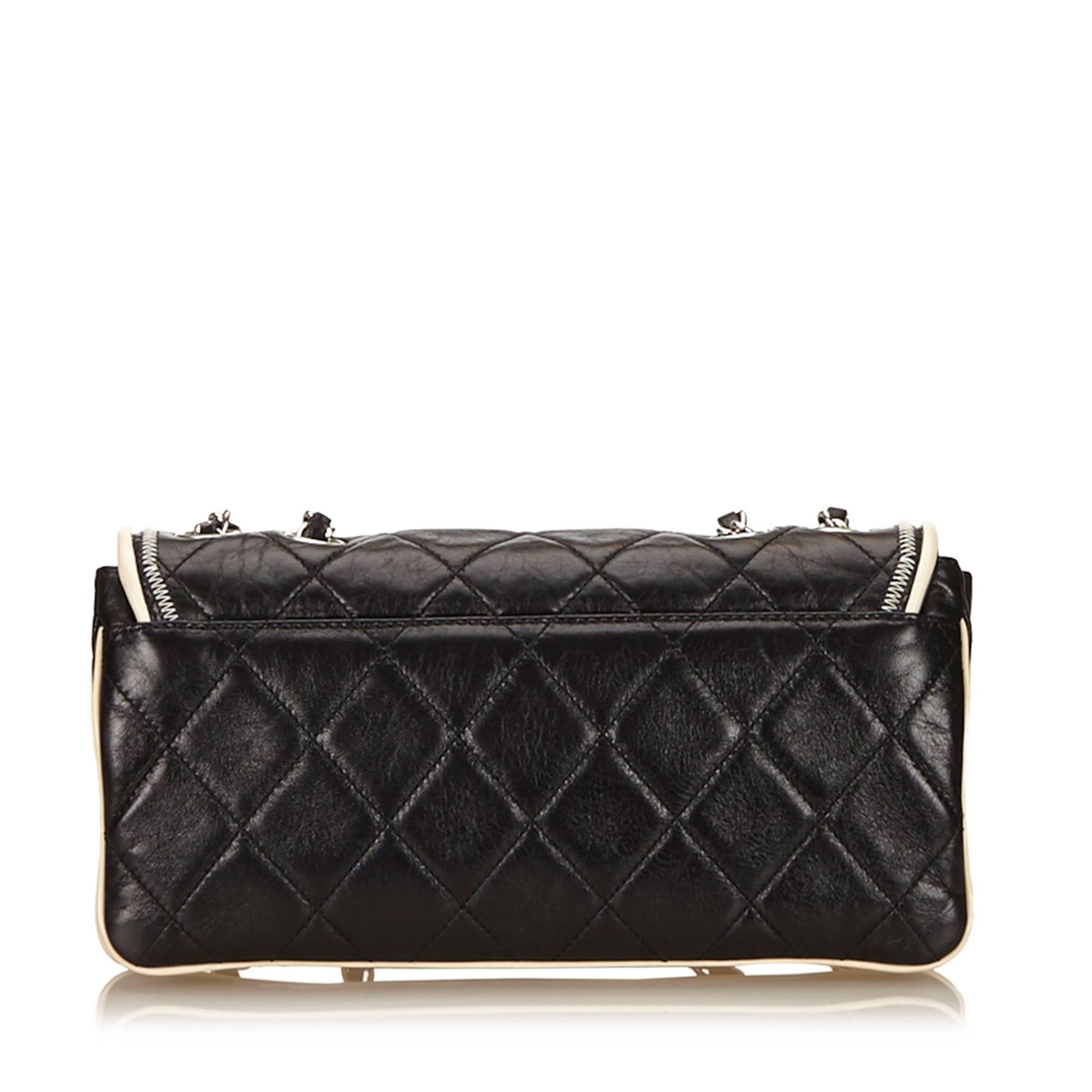 - This Chanel black with white trim piping east west flap bag features a quilted leather body with zipper details, silver-tone shoulder chains, a front flap with a twist lock closure, and an interior zip pocket.

- Made in France. 

- Size 27cm x
