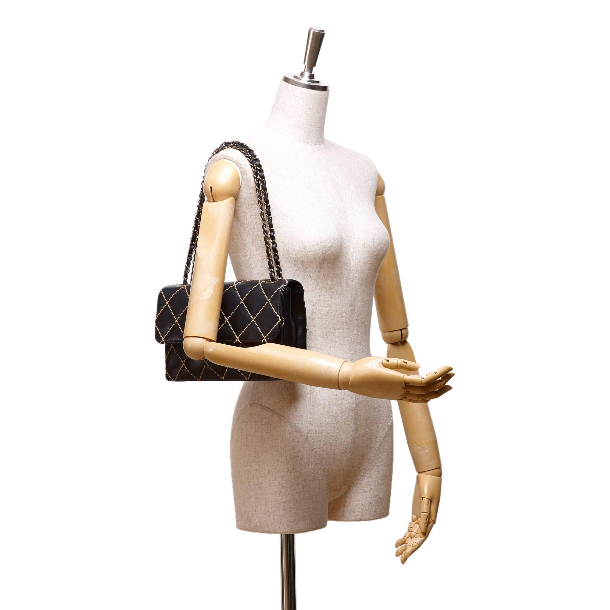 - This Chanel Surpique black and beige contrast diamond wild stitching  features a calfskin leather body, a bronze-tone woven chains, an open top, a front flap with interlocking Cs, and interior zip pockets. 

- Made in France. 

- Size: 24.5cm x