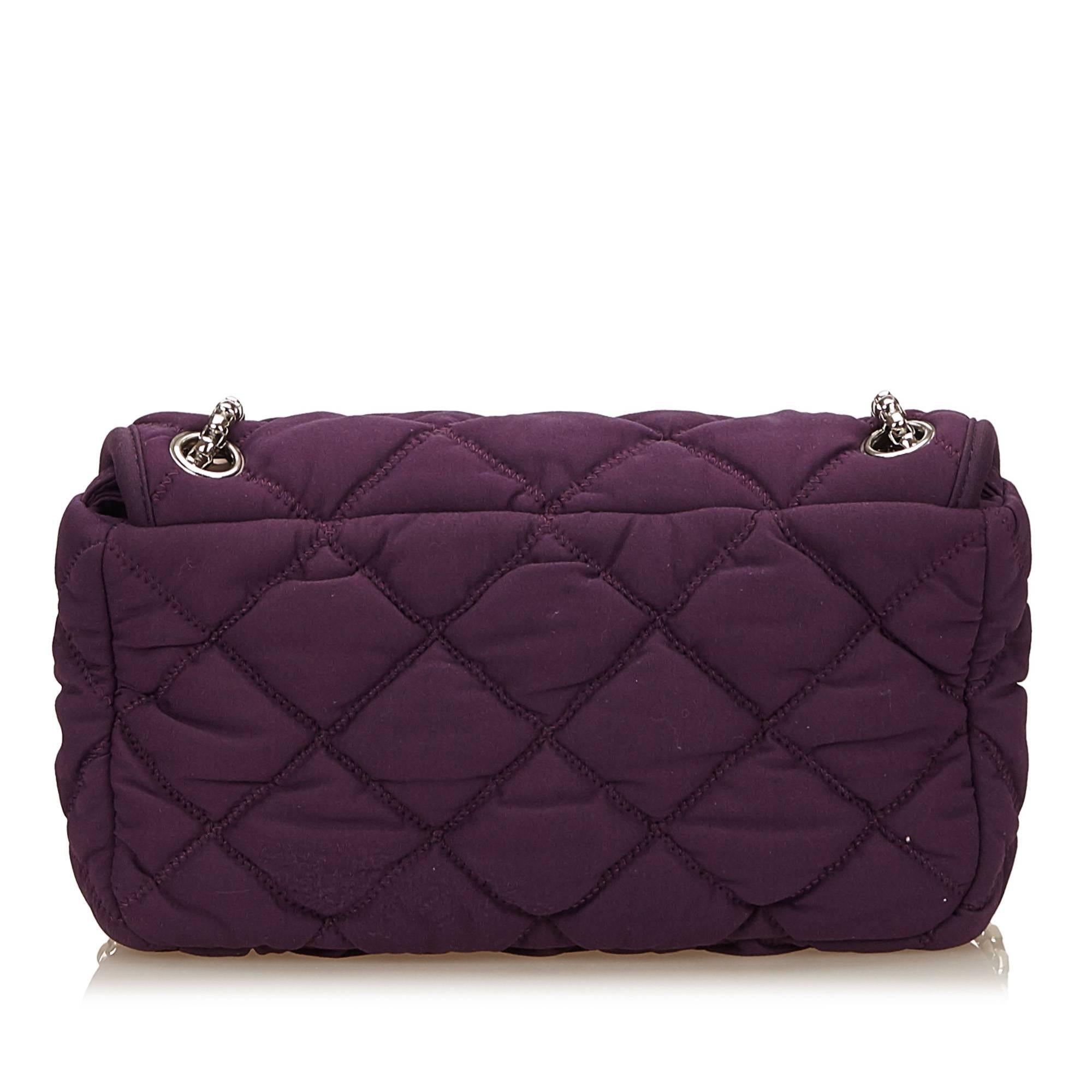 - This Chanel Matelasse style purple bubble shoulder bag features a nylon body, nylon and silver chain shoulder straps, flap top with silver interlocking "CC", and interior zip pocket. Love the purple colour in Chanel, its unusual and easy
