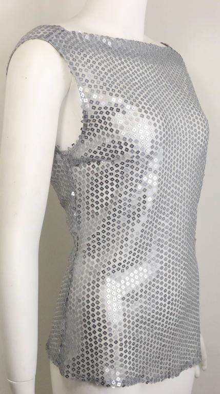 - Vintage 90s Costume National silver square sequins see through top with asymmetric back. Featuring a back zipper closure. A really sexy and beautiful made top and still have tag attached to it! 

- Made in Italy.

- Size 40. 

- 95% Polyaster, 5 %