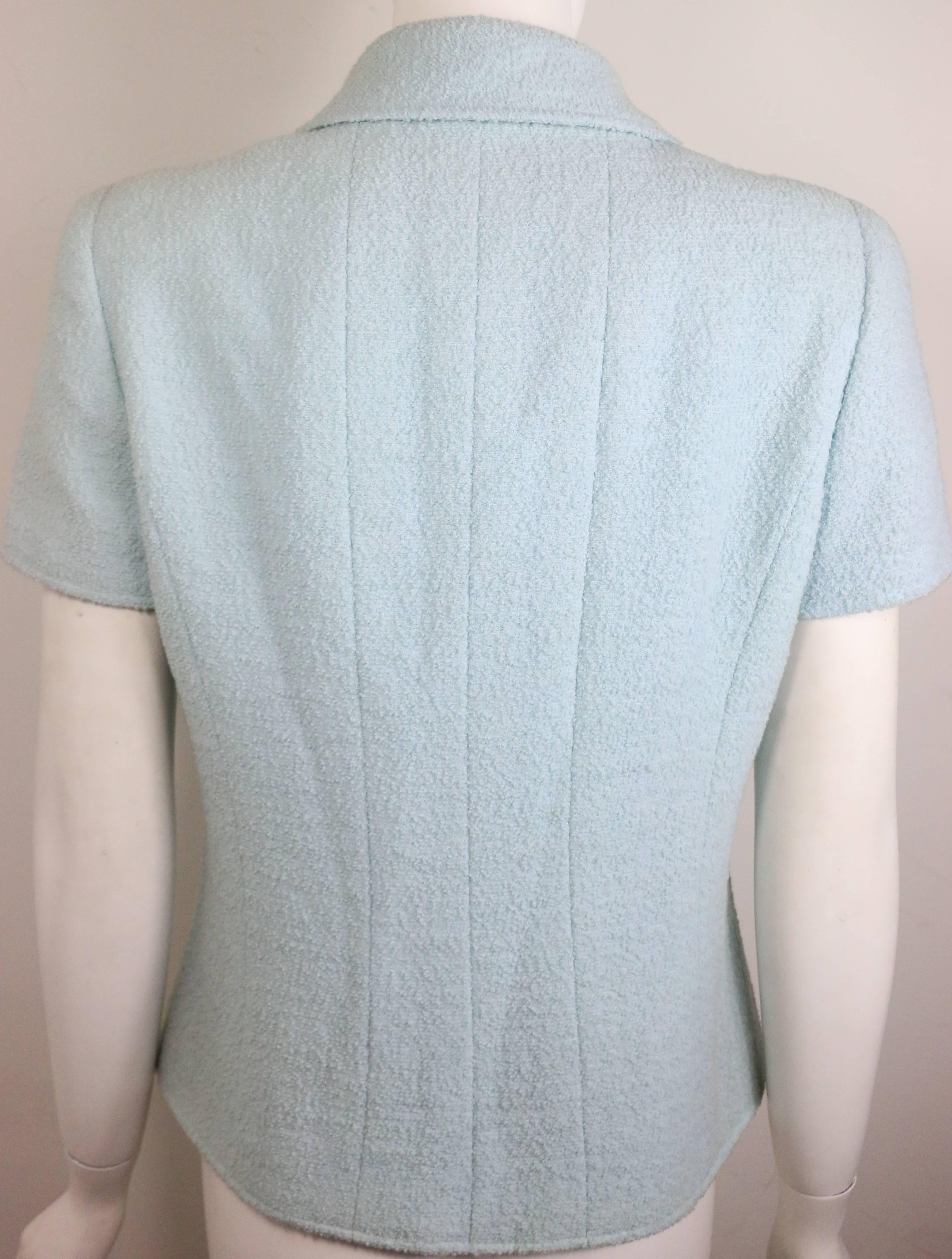 - Vintage Chanel baby blue boucle wool double breasted short sleeves jacket from 1996 collection cruise. 

- Made in France. 

- Size 40. 

- 95% Wool, 5% Nylon. 

- Include: Orignal Hanger. Orignal tag still attached to it. 



