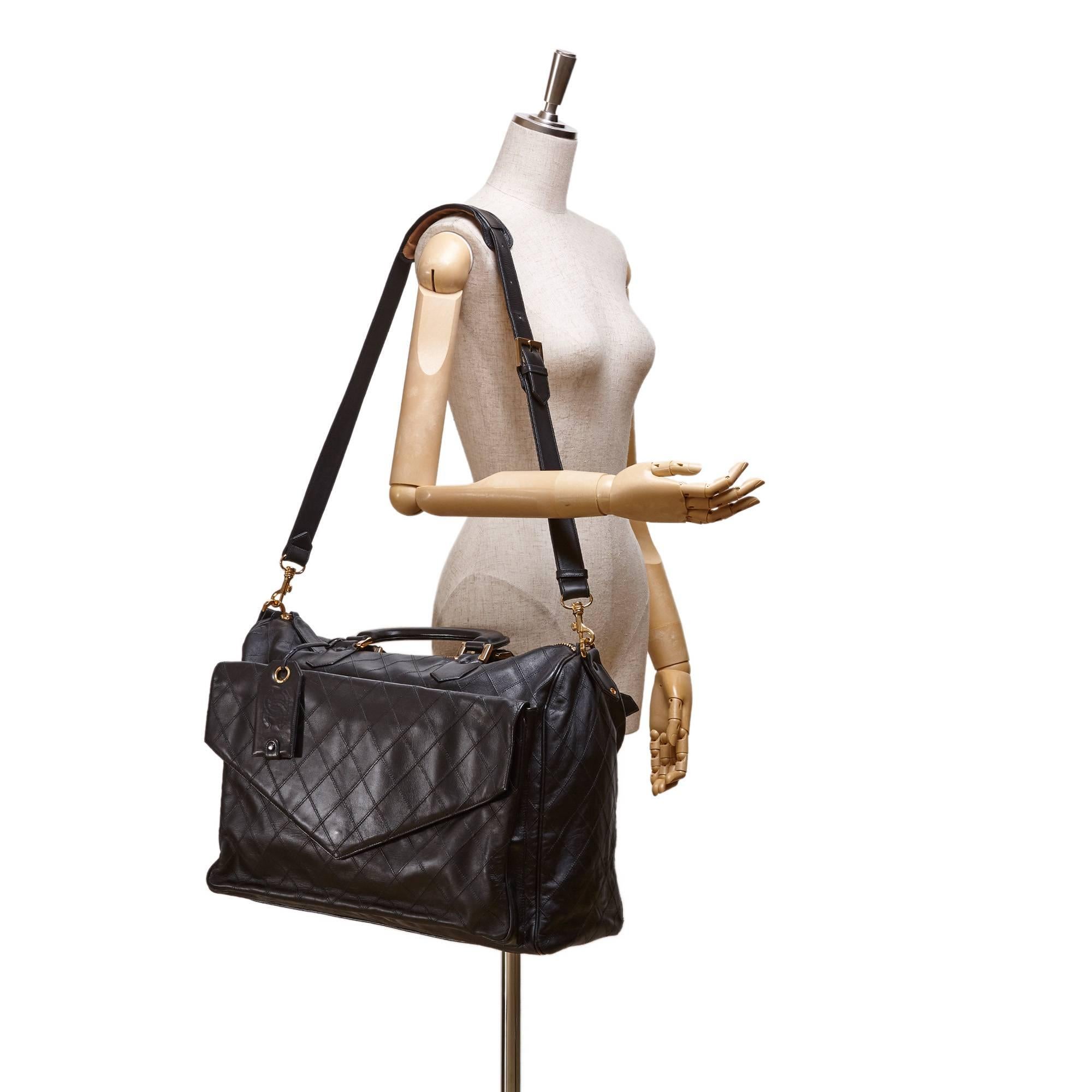 - This vintage 90s black Metelasse shoulder duffel bag features a leather body, exterior front flap pocket, exterior back zip pocket, rolled leather handles, top zip closure, and interior zip pockets.

- Made in Italy. 

- Size: 45cm x 33cm x 20cm.