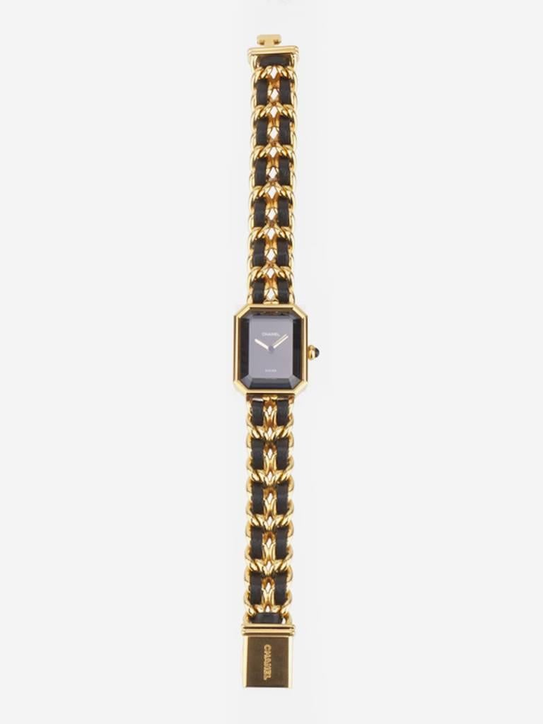 - Vintage 90s Chanel black leather gold plated watch in Size L. This premiere watch is one of the classic style of Chanel. 

- Made in Switzerland. 

- Size: Face Dimensions: 2 x 2.5 cm. Length: 16.8 cm. 

- Include: Booklet. 

- Product Code: