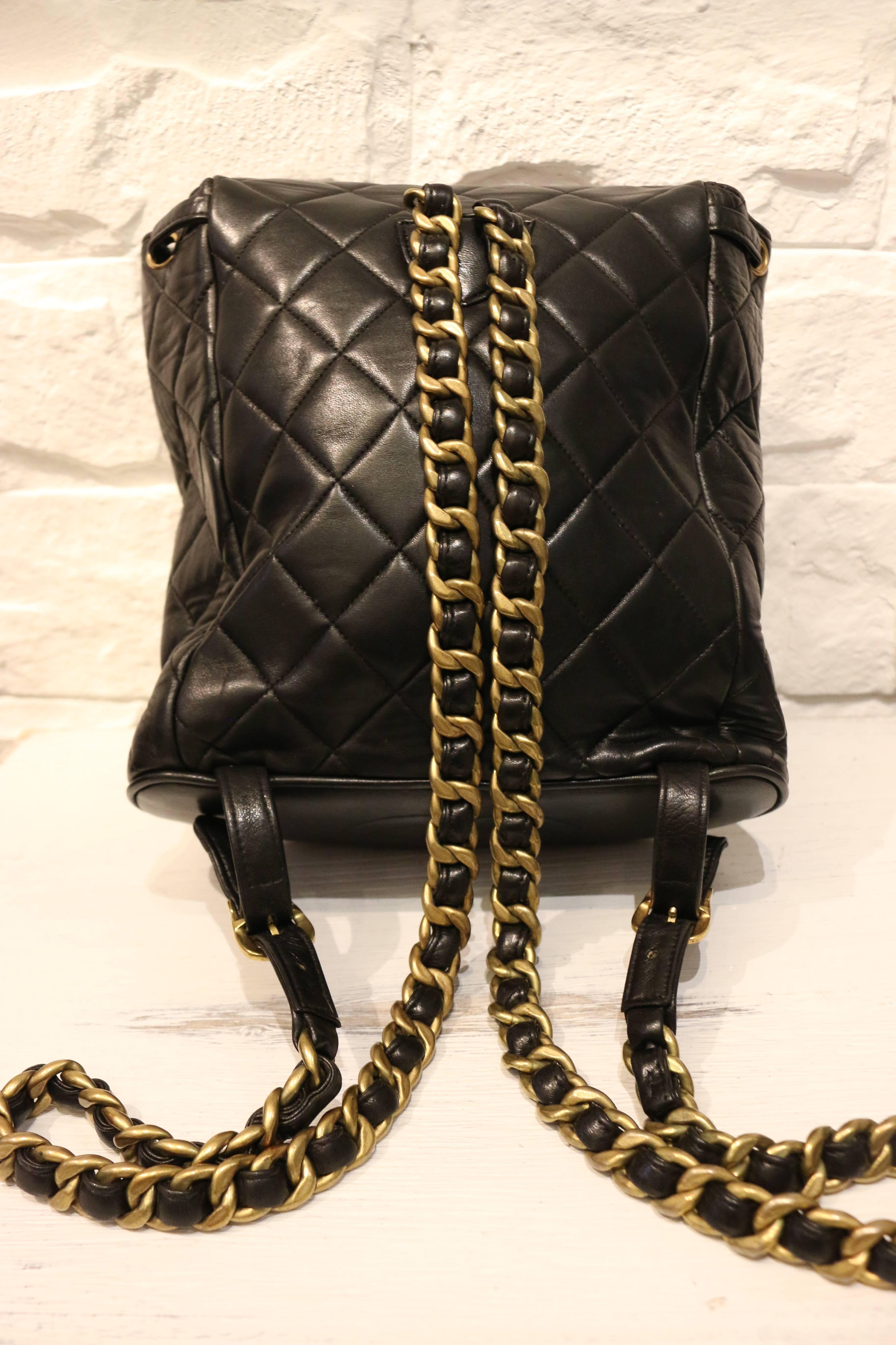 - Vintage 90s Chanel black duma lambskin leather quilted backpack. Featuring a drawstring fastening and a quilted flap with gold toned 