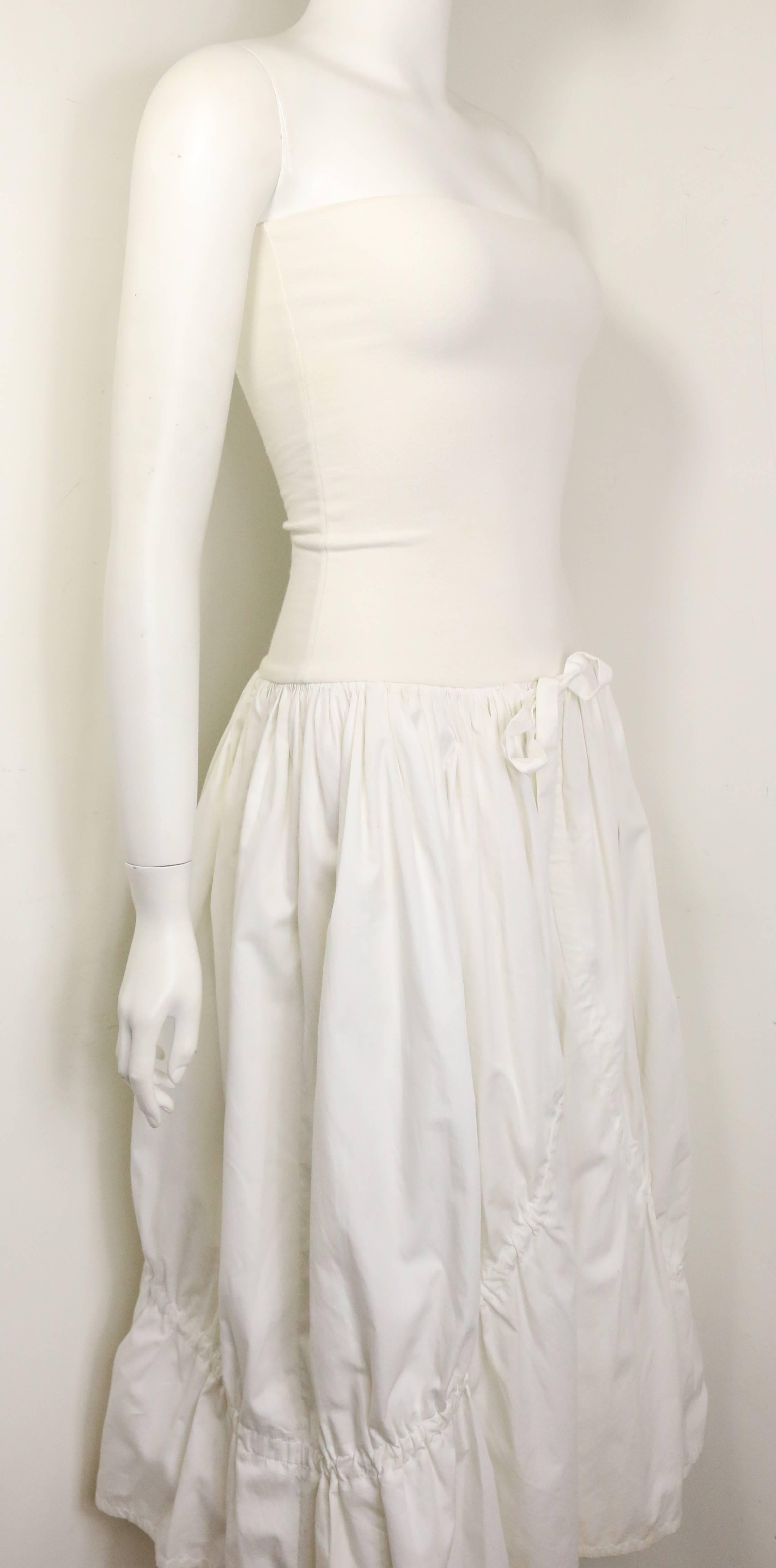 - Vintage 90s Dolce and Gabbana white cotton strapless dress. Featuring two layers seaming with drawstrings. There are two drawstrings fastening on the outside layer and two drawstrings fastening on the inside. Its a very interesting dress with