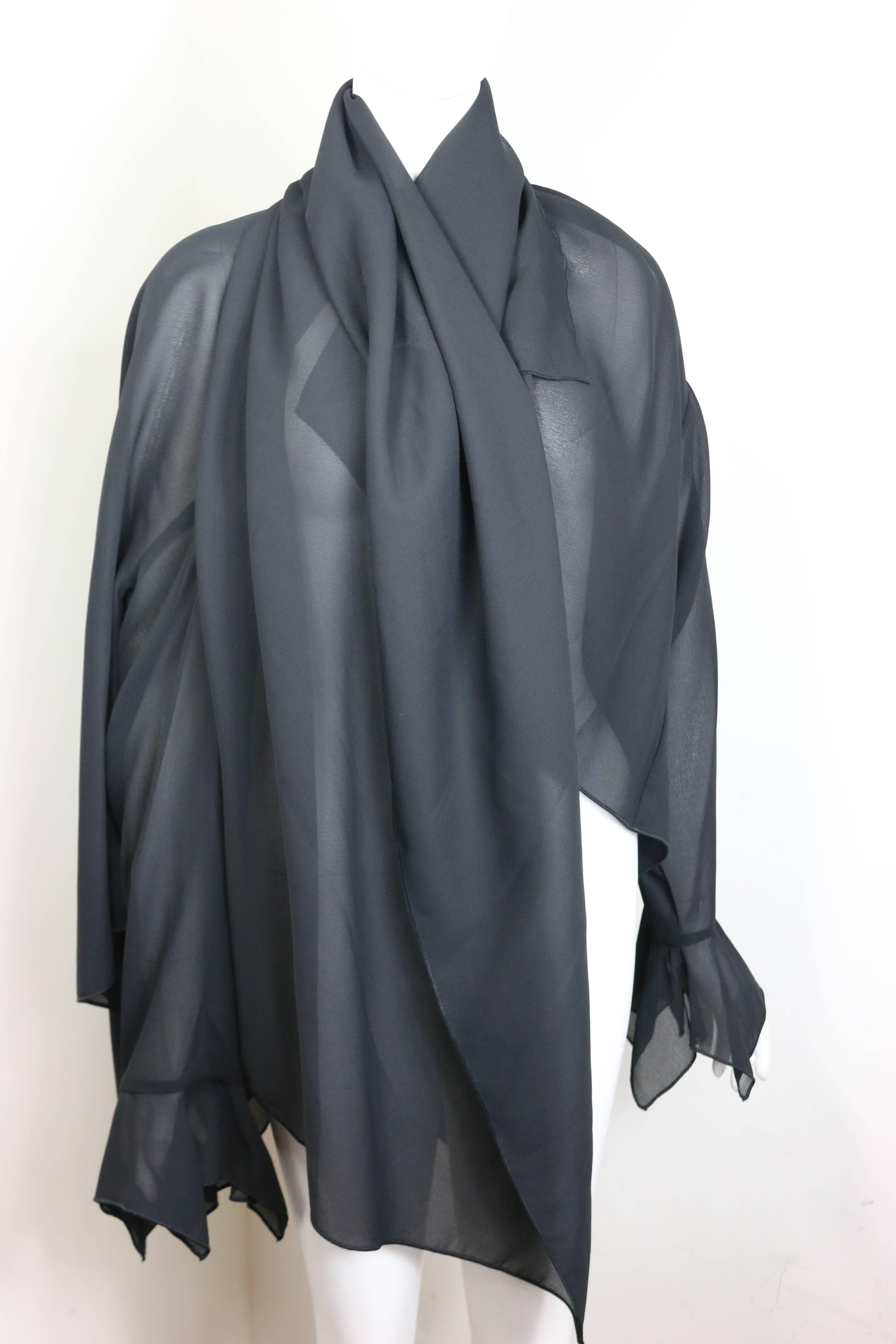 - Vintage 90s Ikons black polyester cape jacket with sleeves. Featuring a silver hardware button around the neck fastening. This beautiful layer shape cape jacket is unique and you can wear it in many ways. One of a kind!

- Made in Italy. 

- Size