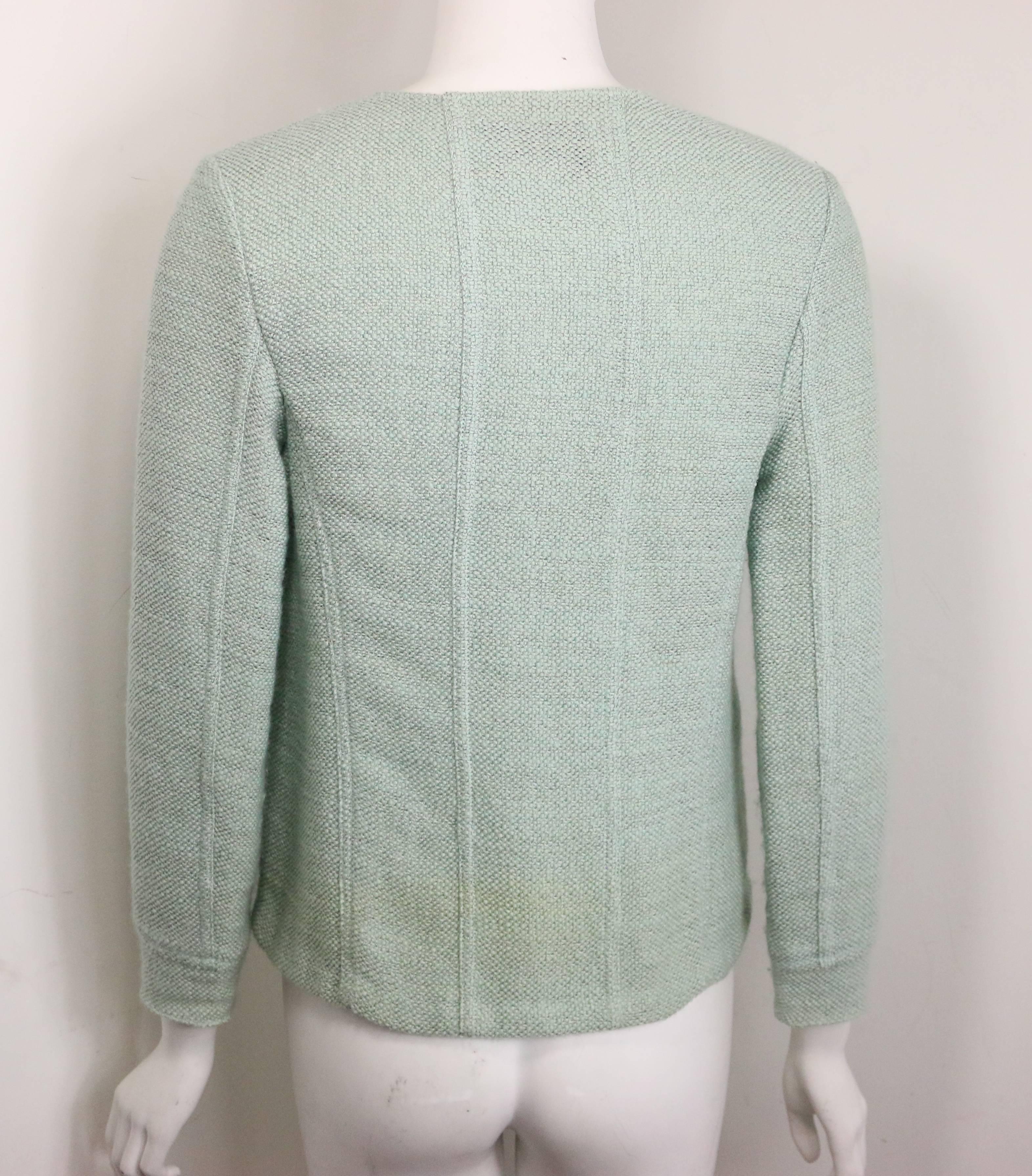 - Vintage Chanel light green boucle wool 3/4 sleeves jacket from 1999 cruise collection. Featuring a round neckline. Four front flap pockets and four transparent "CC" buttons fastening. A snap button on the top closure. A good summer