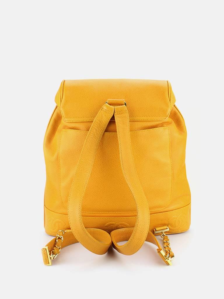 - Vintage 90s Chanel Orange caviar leather Backpack with pouch. Featuring a gold toned "CC" interlock hardware flap with drawstring closure. A slip pocket on the back, an interior zipper pocket. This Chanel orange backpack is one of a